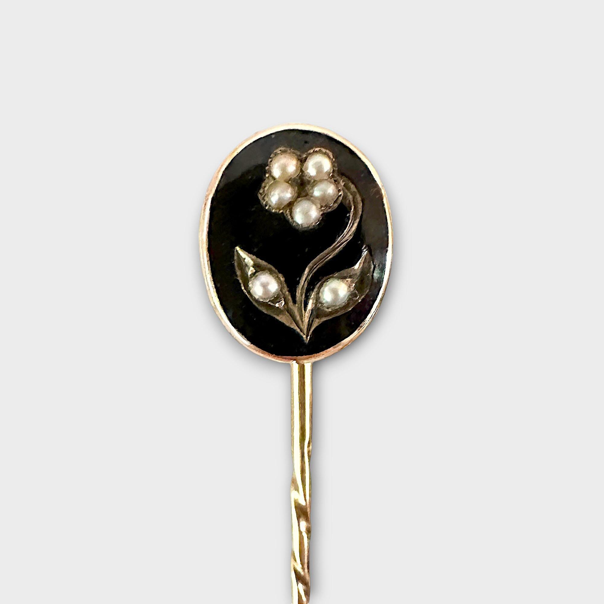 Victorian mourning stick pin featuring black enamel oval plaque with pearl studded forget me not detail on a barley twist pin all in 15ct gold