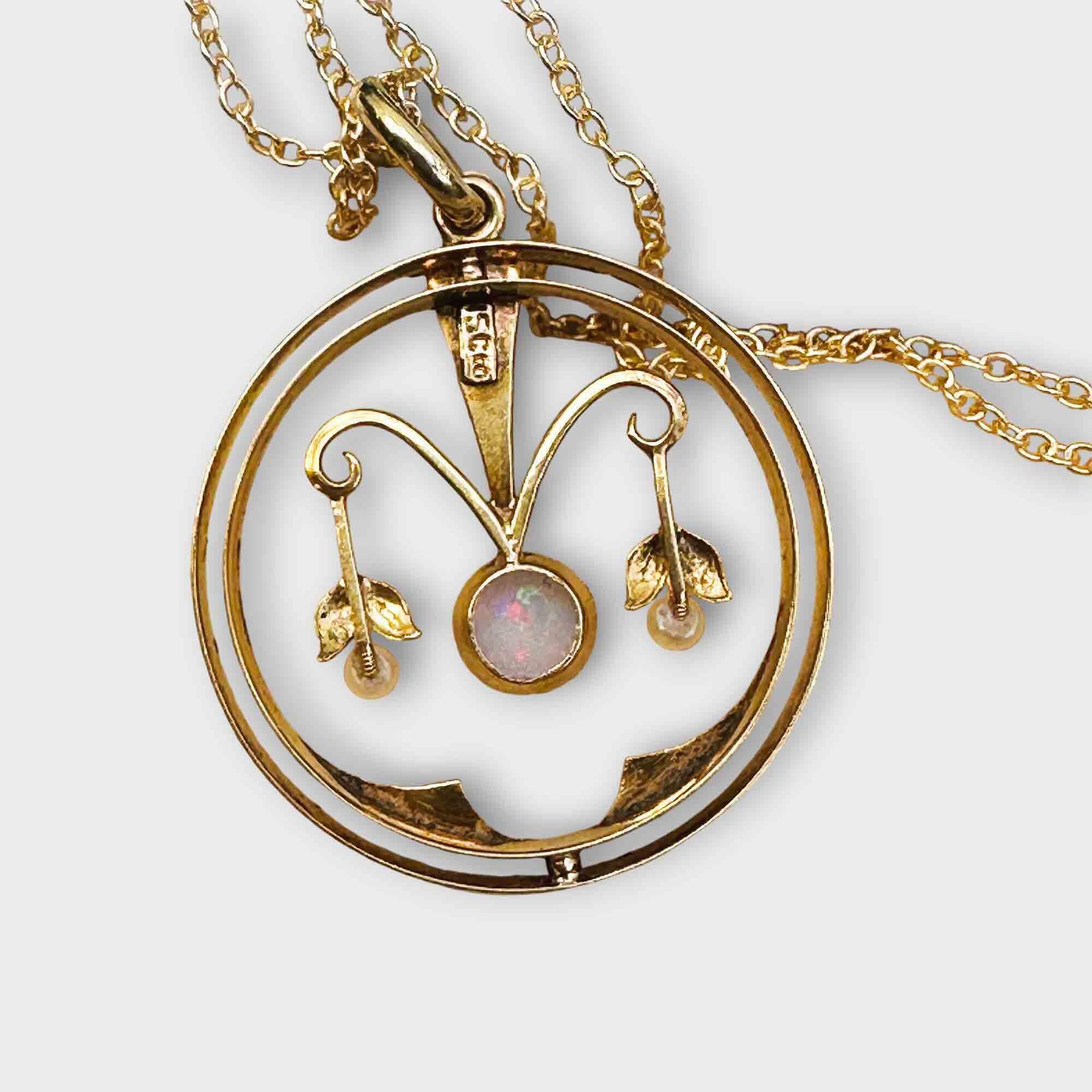 Art Nouveau circular openwork pendant with seed pearls and opal centre crafted in 15ct yellow gold