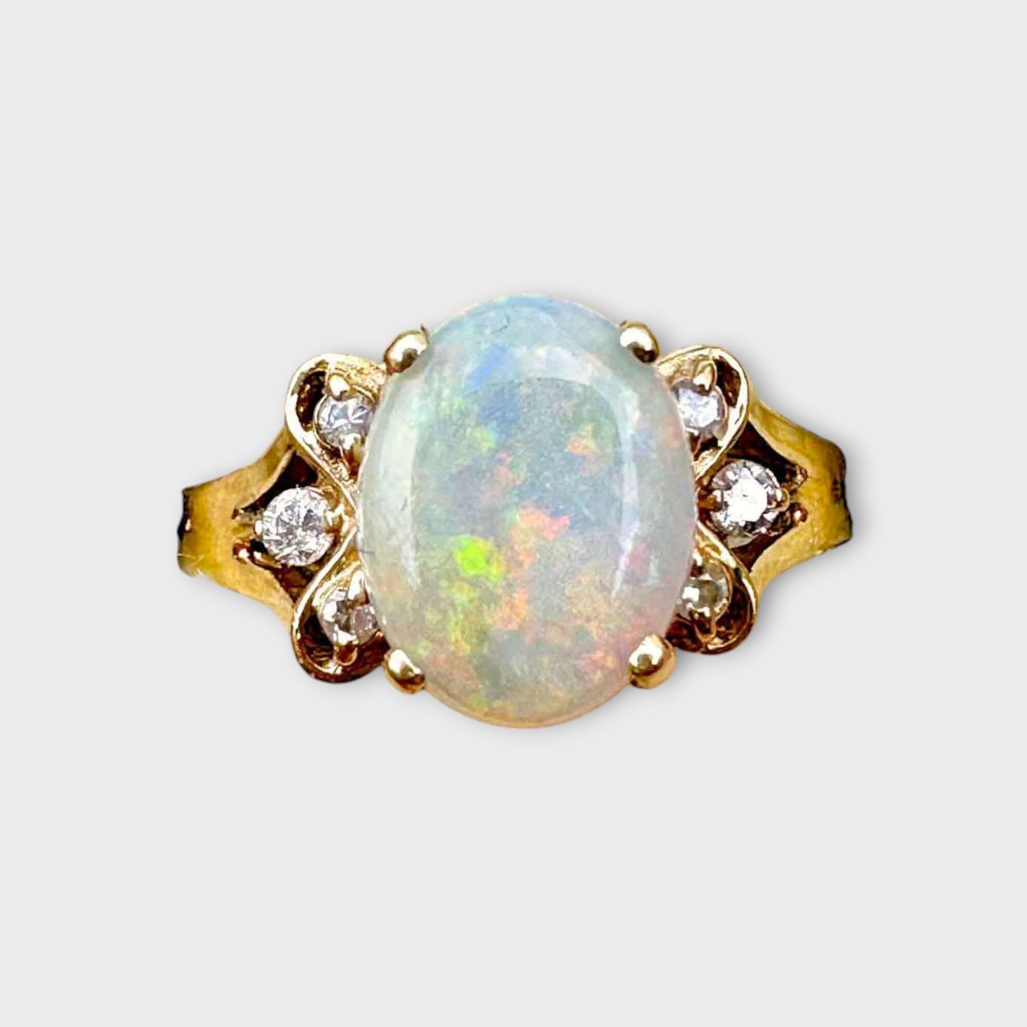 modern 14ct yellow gold ring with oval opal and diamond studded butterfly shoulders