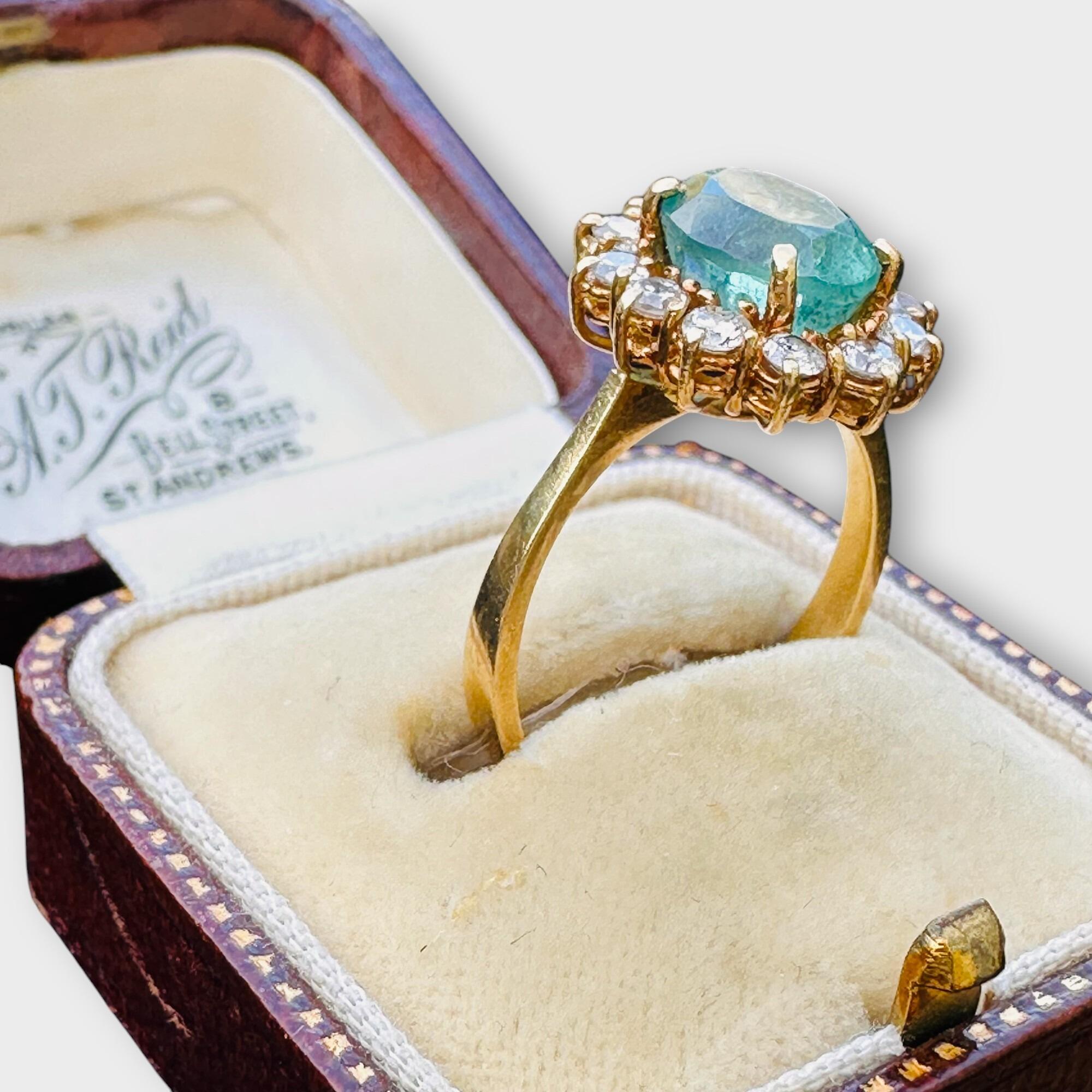 Vintage 18ct yellow gold oval emerald and brilliant cut diamond cluster daisy ring