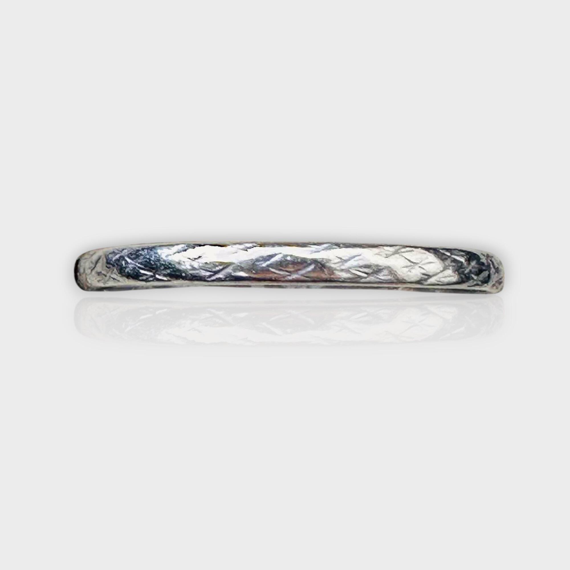 Art Deco platinum wedding band with geometric engraved pattern around the band