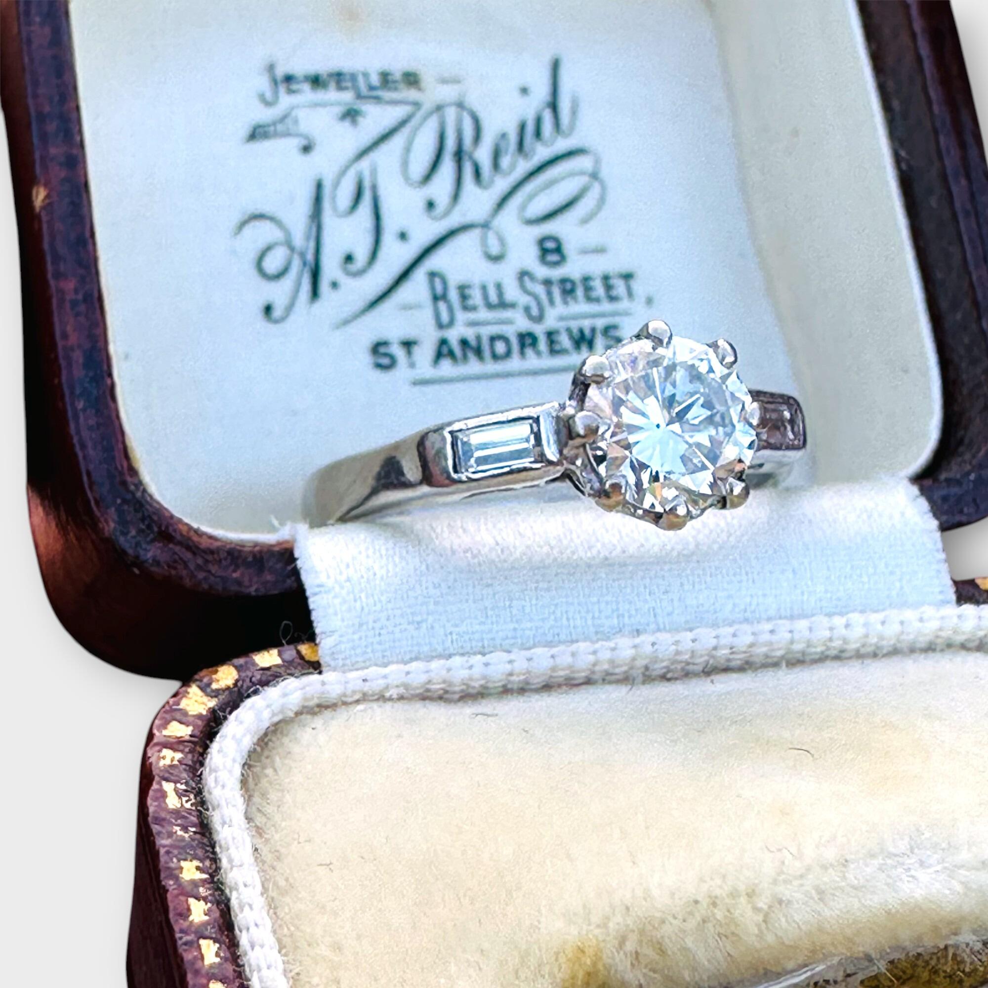 Antique Art Deco solitaire diamond ring with diamond baguette shoulders in 18ct white gold