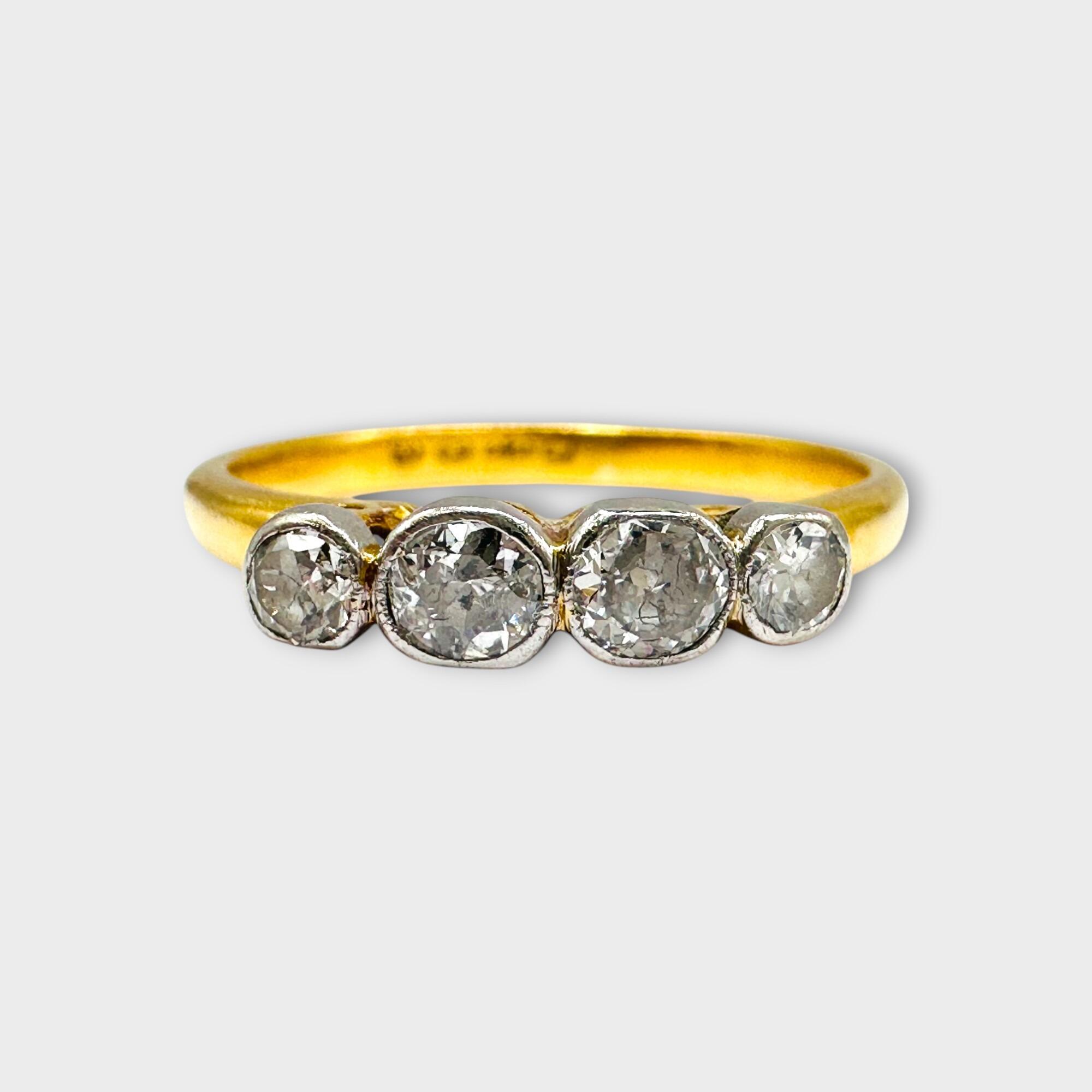 Elegant Art Deco 22ct gold four-stone diamond ring forward facing on grey background