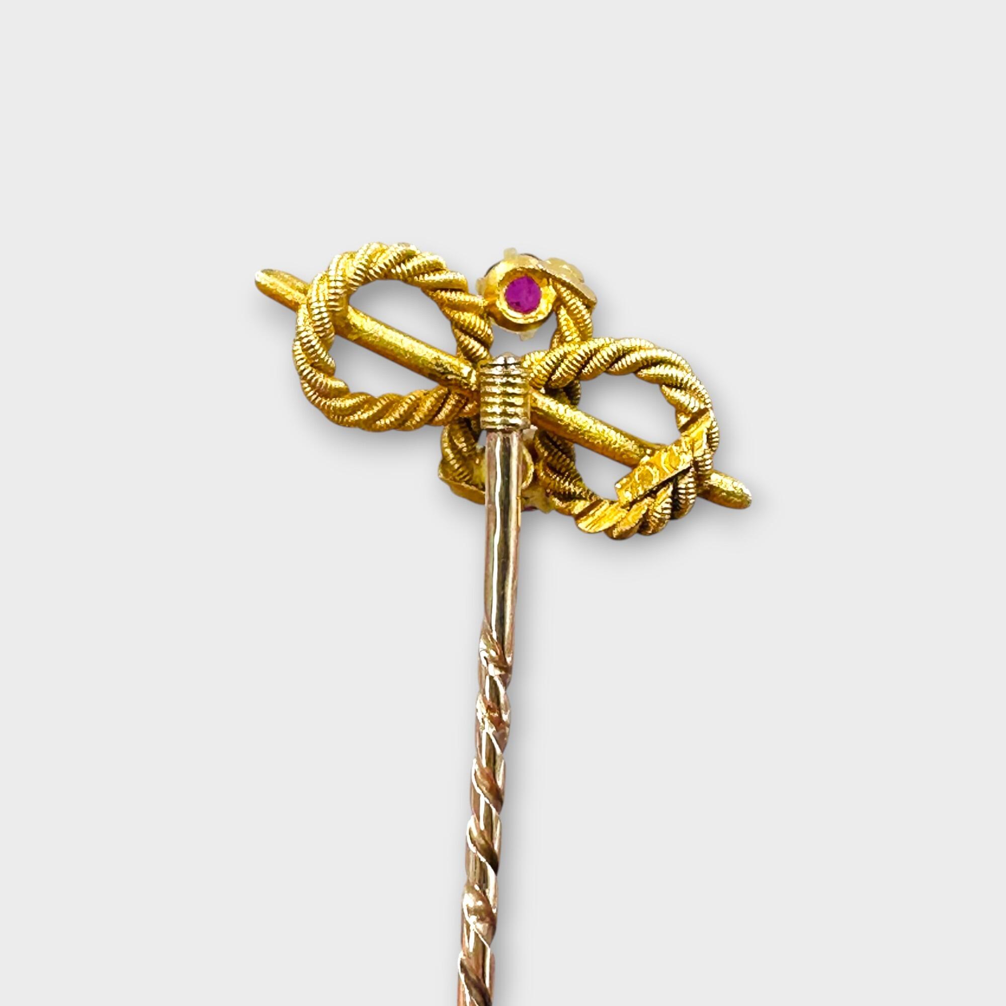 Edwardian 9ct yellow Gold Faceted Ruby Knot Stick Pin reverse view on grey background.