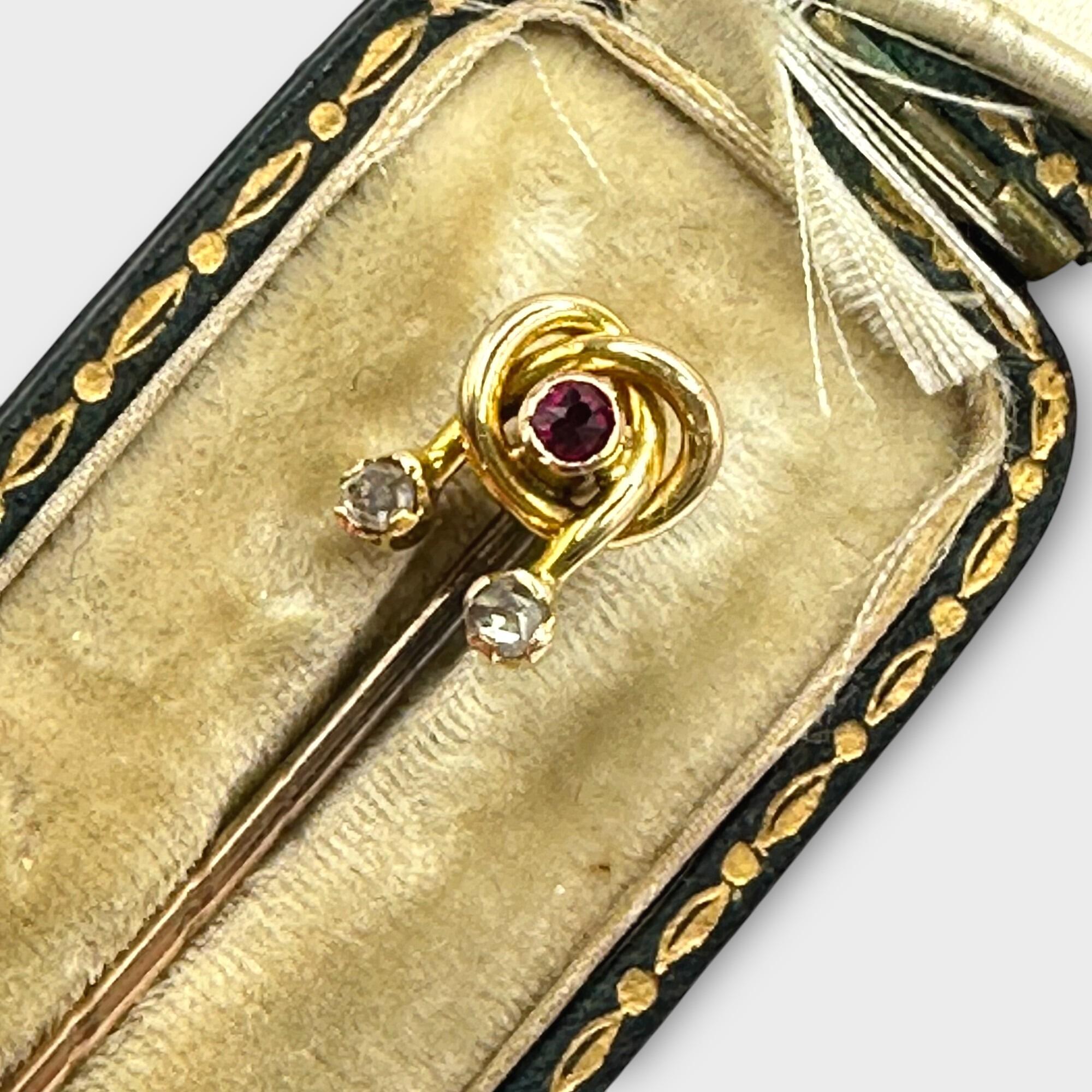 Edwardian 15ct Gold Ruby & Diamond "Lovers Knot" Stick pin in antique box with burgundy background.