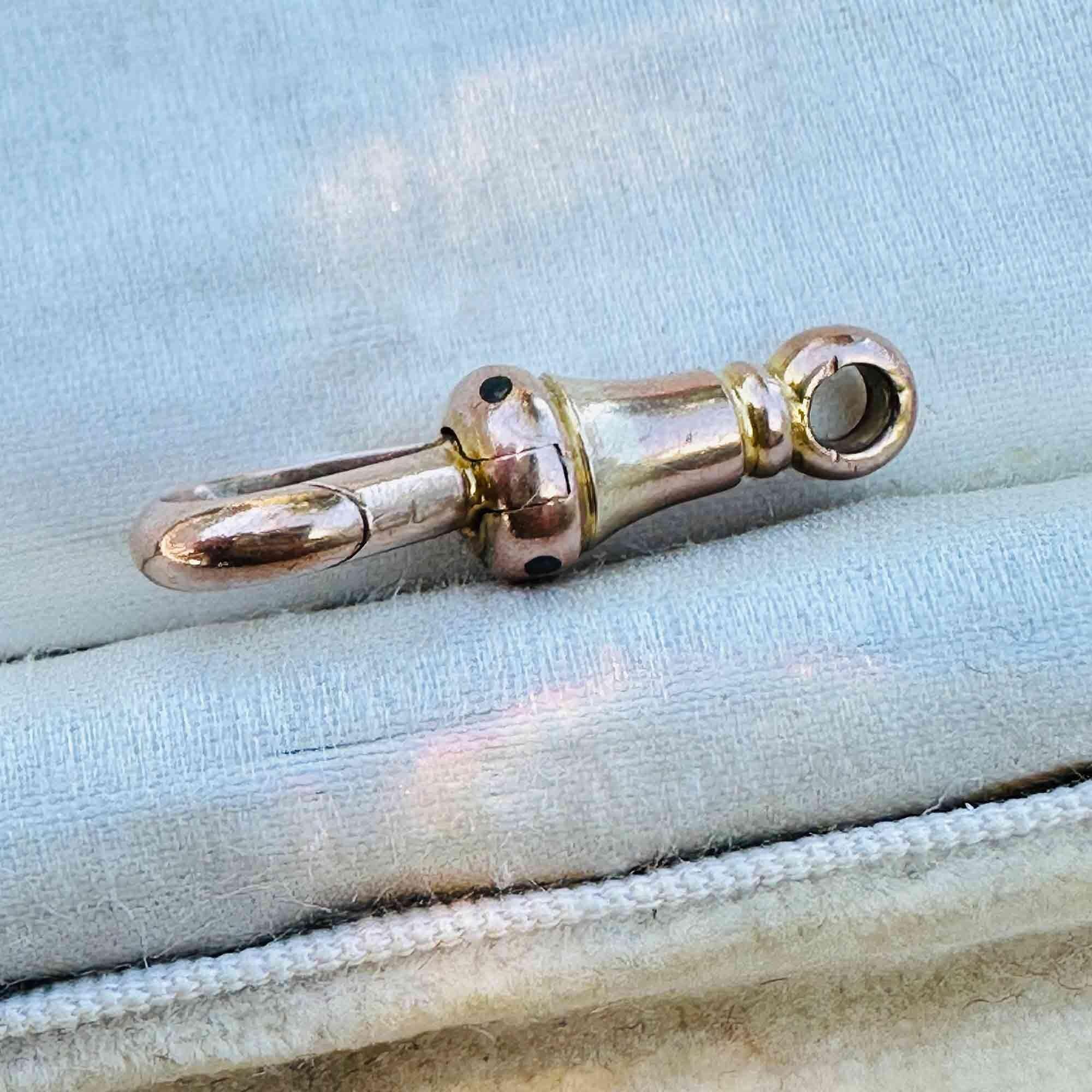 Edwardian 9ct Rose Gold dog clip clasp on antique box, side view.