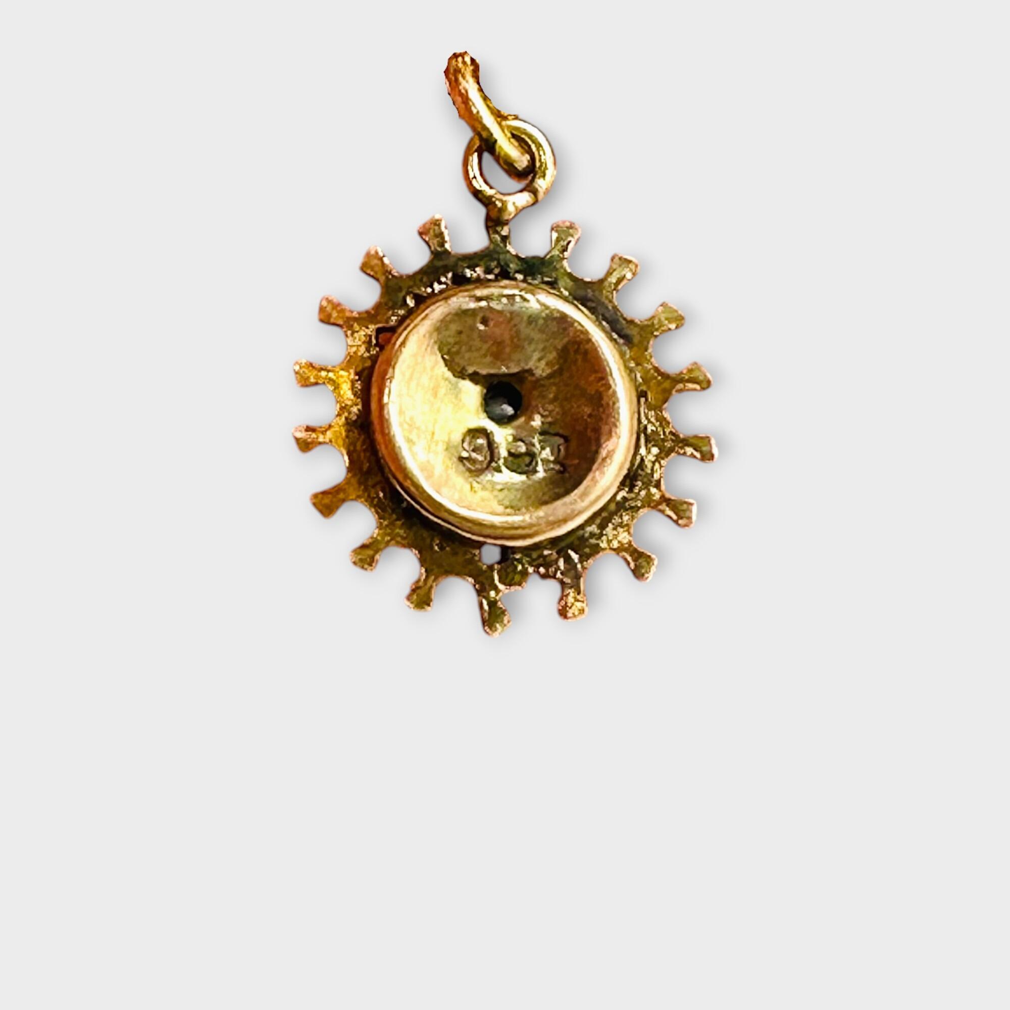 Victorian 9ct Gold, Sunburst Charm / Pendant with red paste on grey background, reversed view