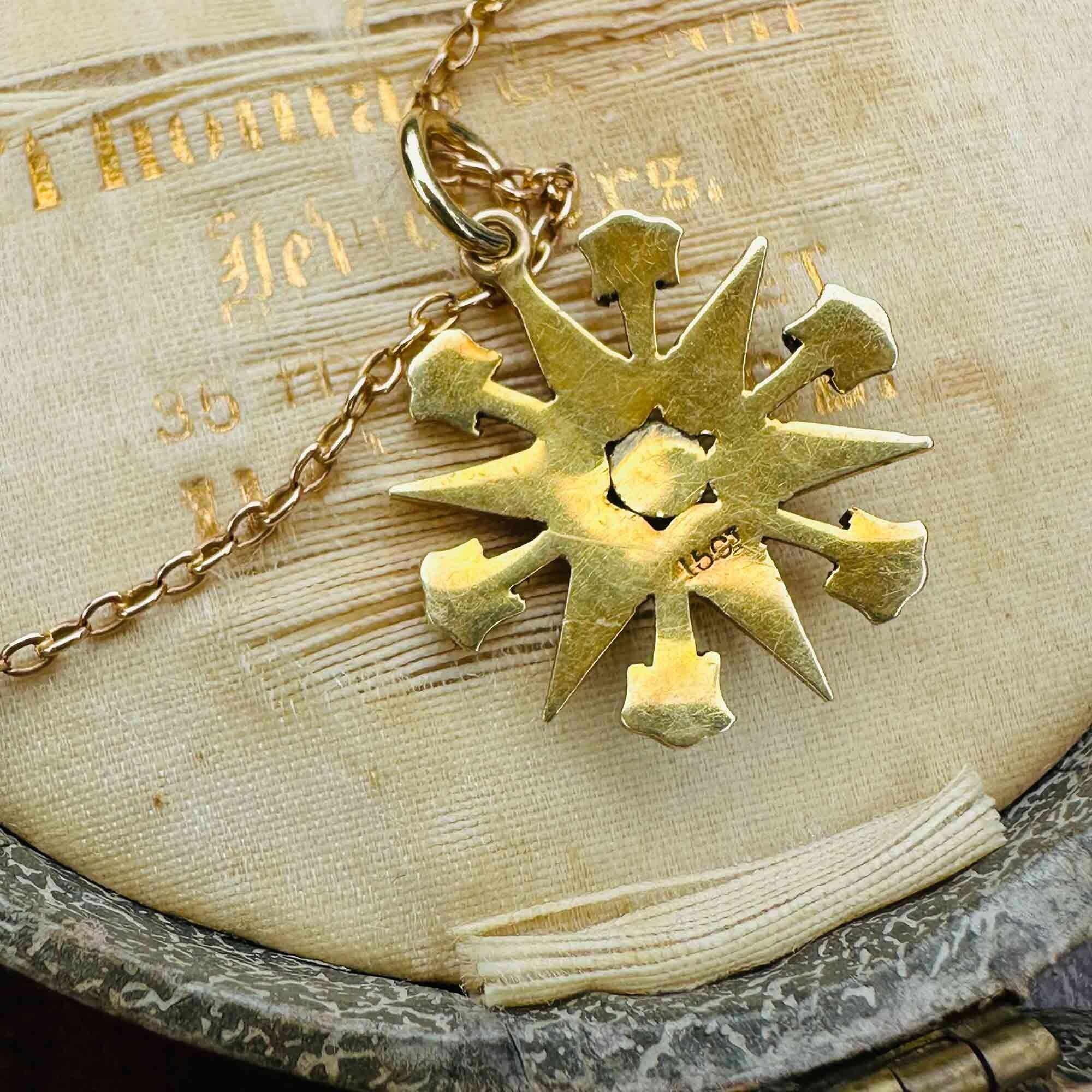 Victorian 15k gold turquoise and pearl star pendant on antique box, reversed view.