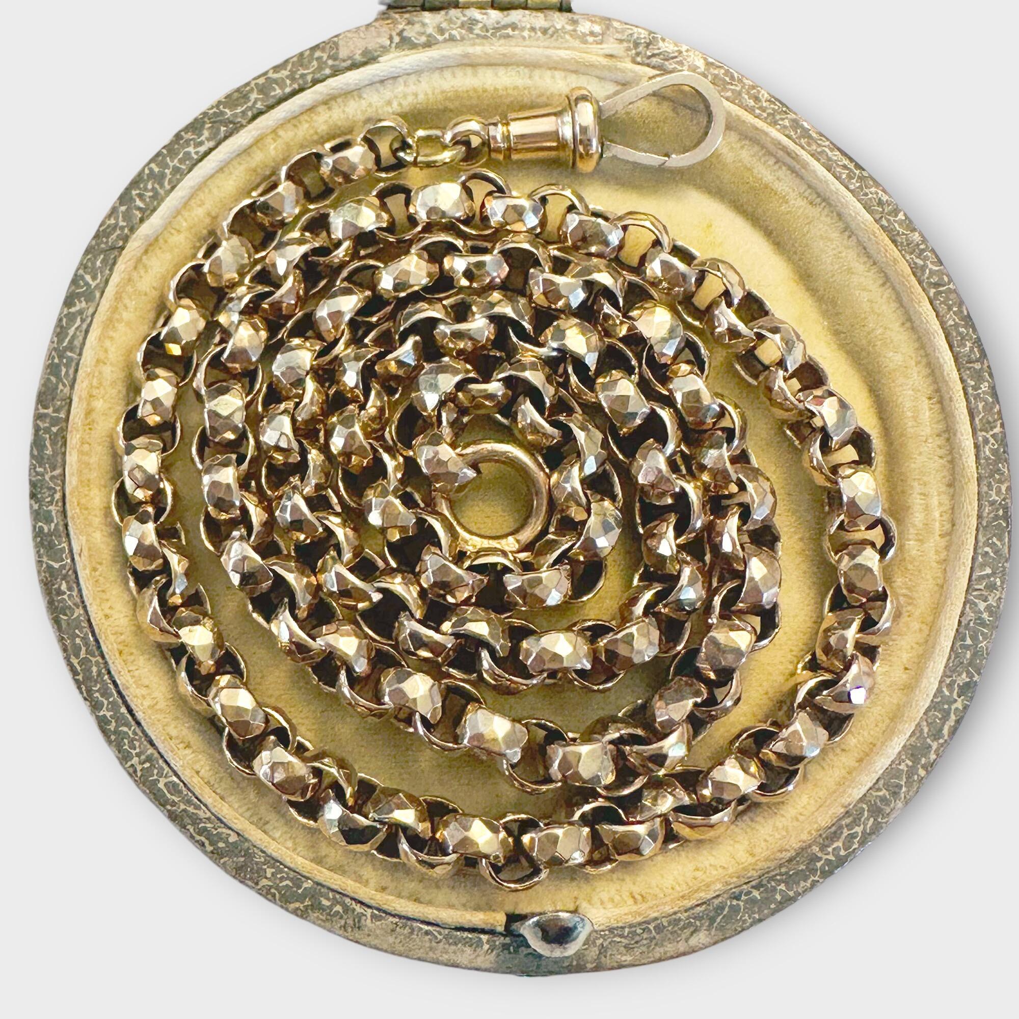 Elegant Victorian faceted gold chain with classic dog clip clasp, photographed coiled neatly against a dark background.
