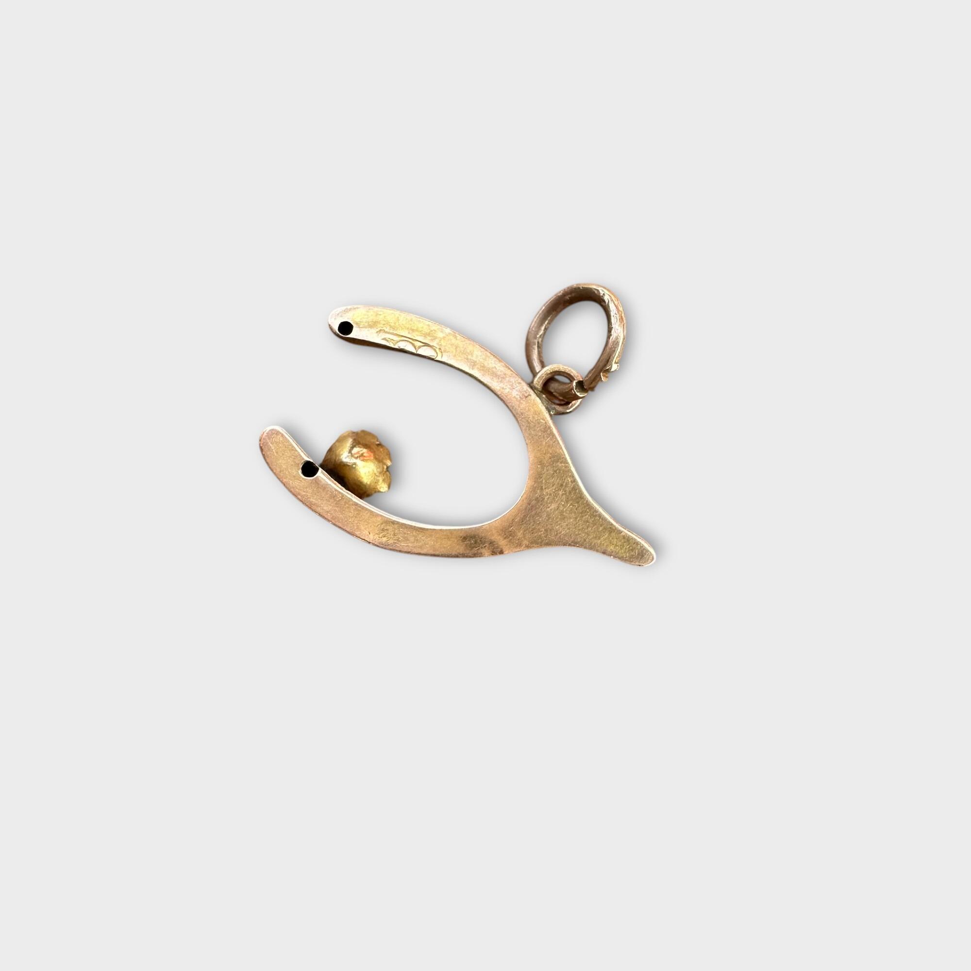 Pretty Victorian wishbone and pearl charm charm made of 9ct (375) rosegold, featuring a delicate wishbone design adorned with a single white pearl on grey background.