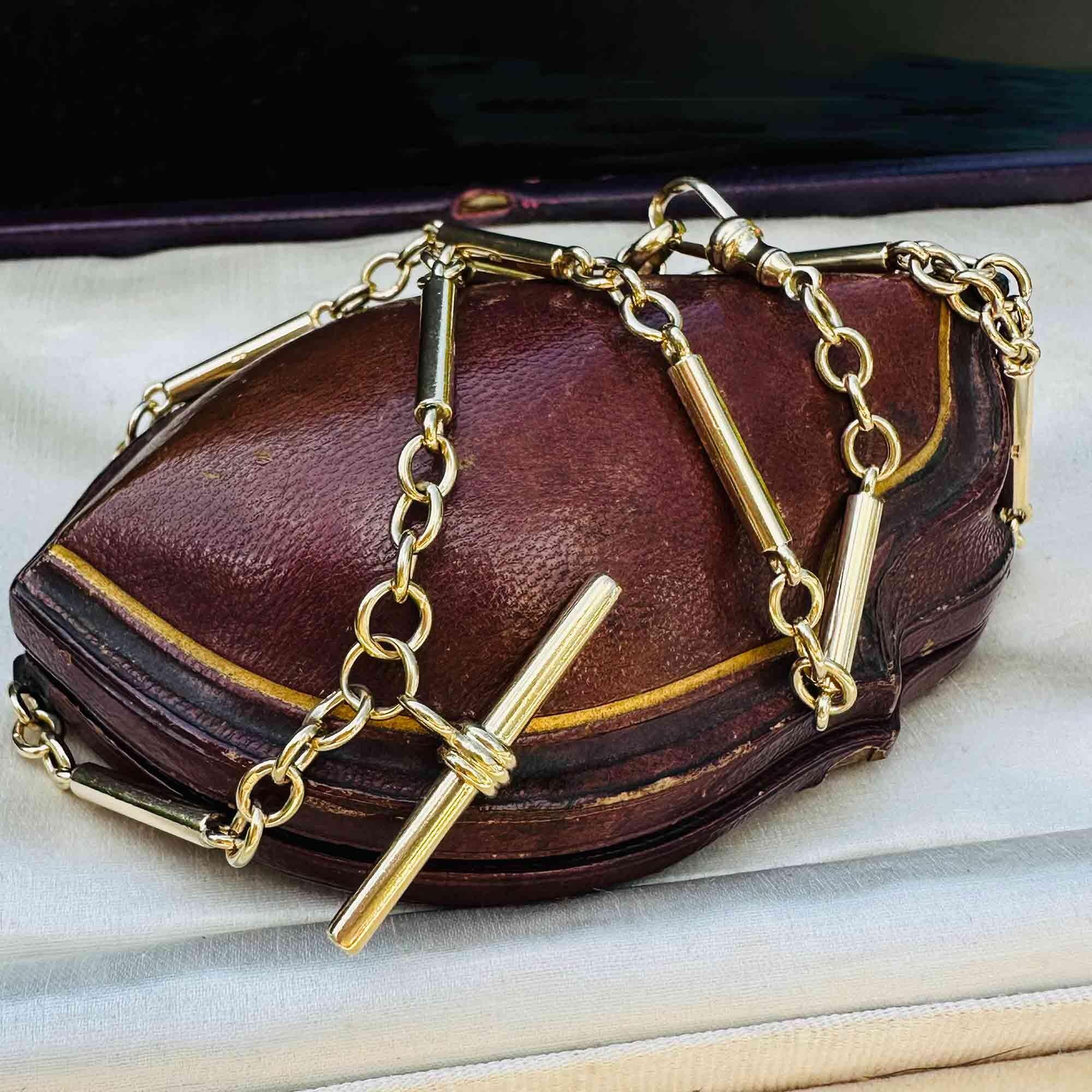 Vintage 9k Yellow Gold solid Tubular & Link Chain with T-Bar Pendant and Dog Clip worn on antique leather box.