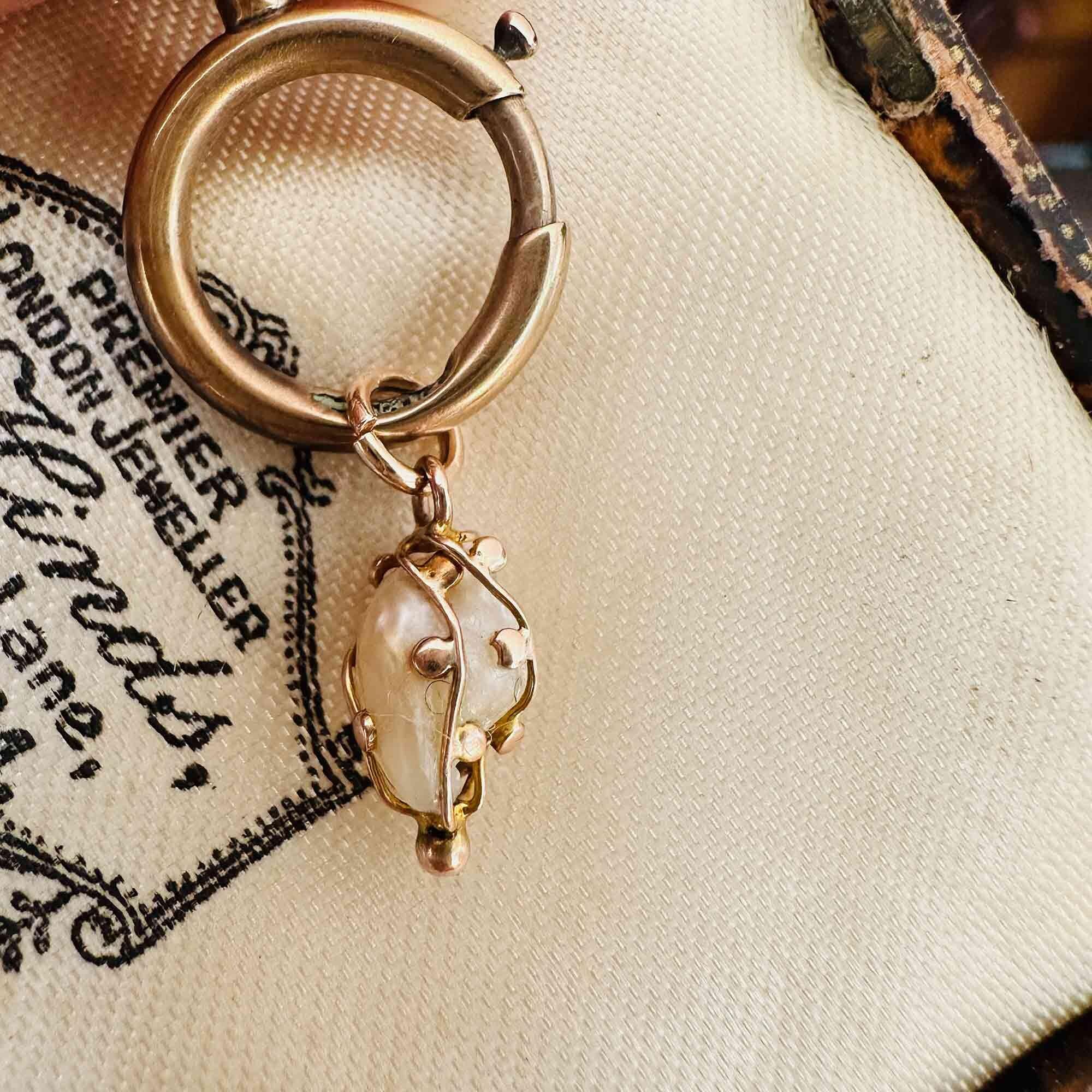 Antique natural Mississippi River pearl pendant in 9k rose gold cage, c.1890, with soft lustre and organic drop shape on antique box.