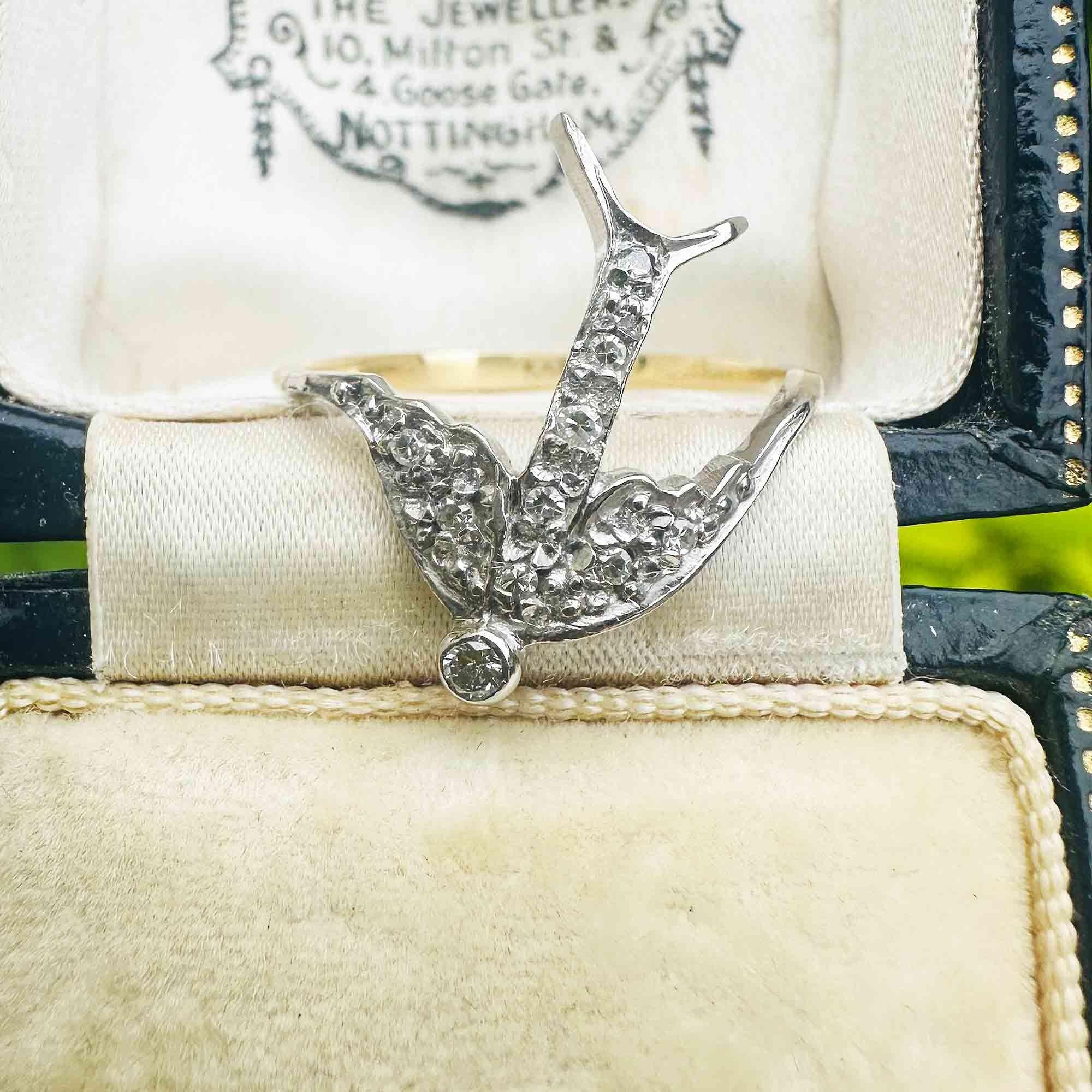 Artistic 14k gold swallow ring featuring diamond-encrusted wings and tail in antique box.