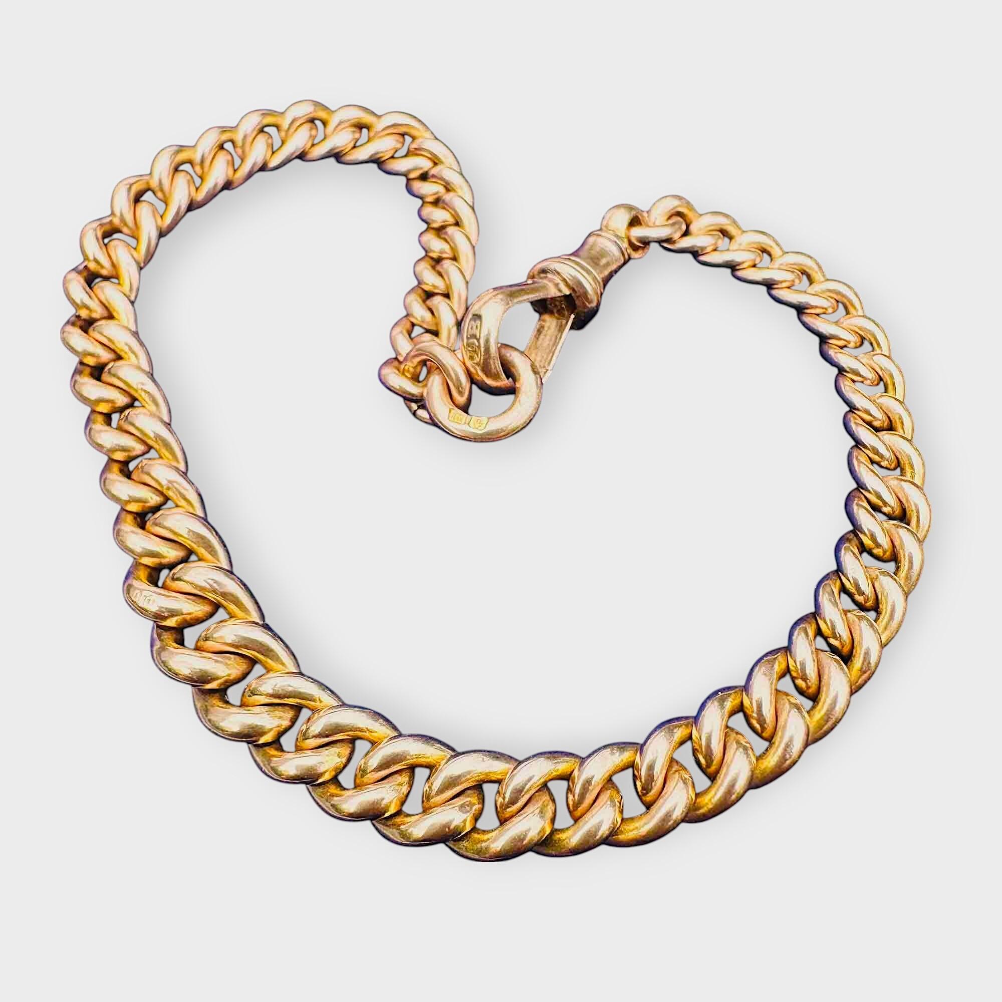 Edwardian 9ct gold curb link bracelet with traditional dog clip clasp on blue velvet pad.