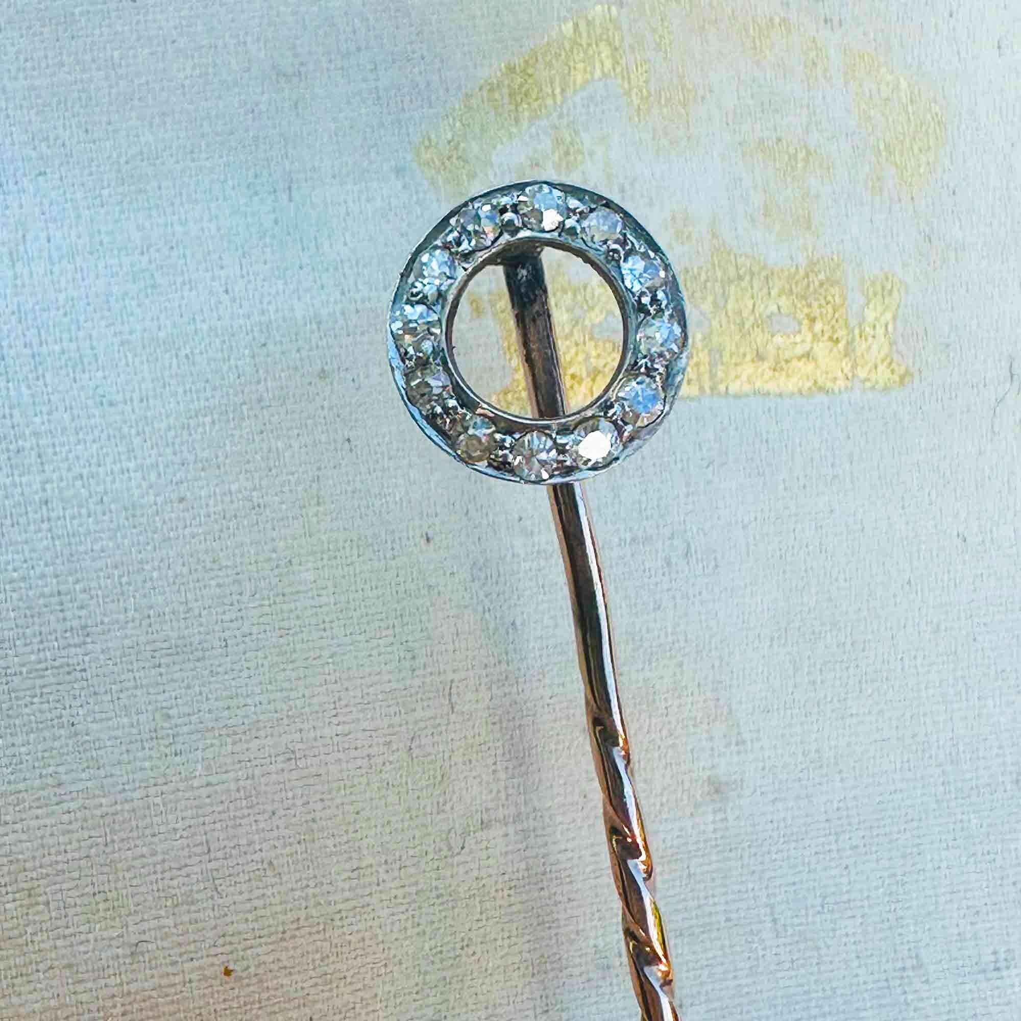 Antique stick pin crafted in 15k rose gold with a diamond-set circle motif on antique box.
