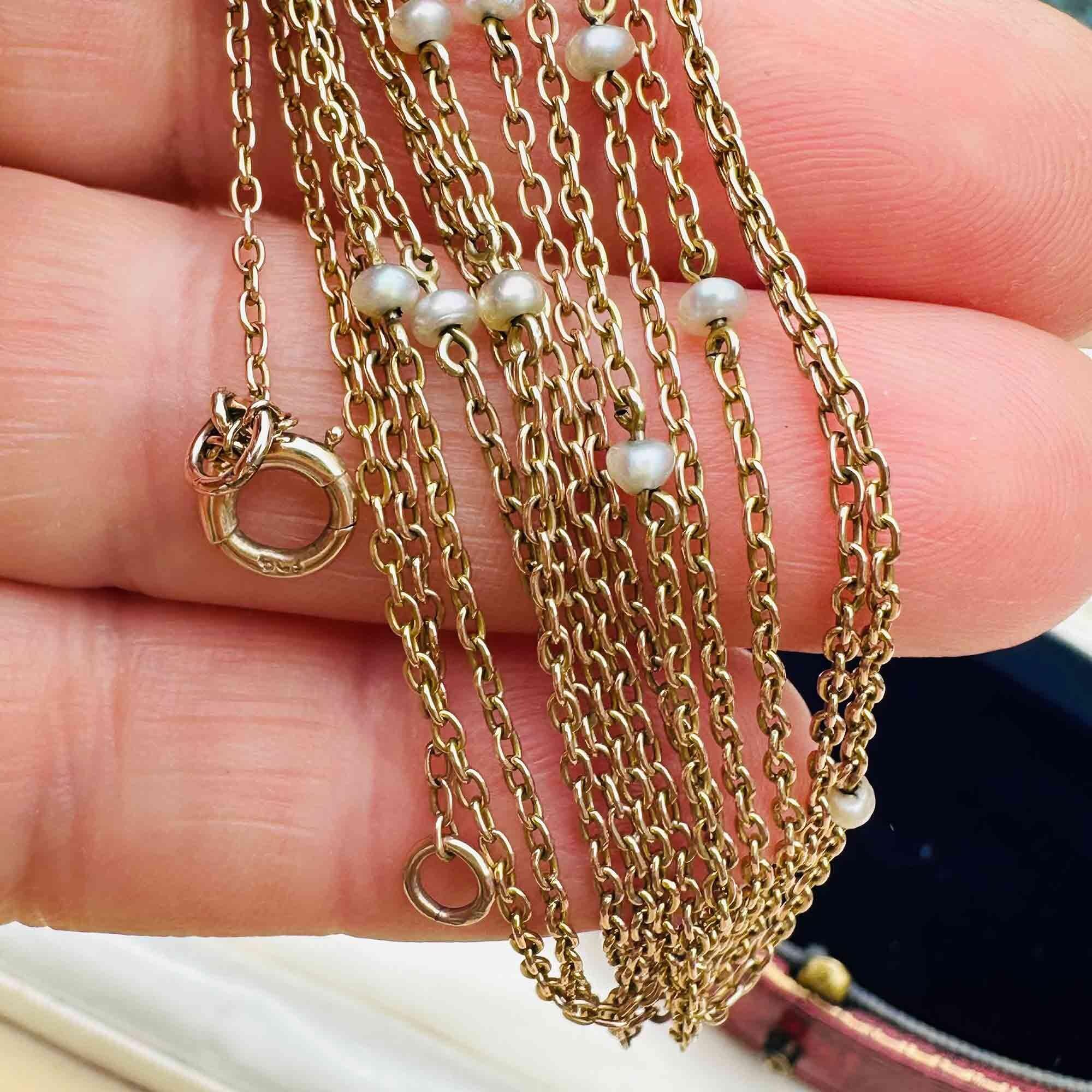 Antique 149cm gold pearl station muff chain with natural pearls ,modelled in hand.