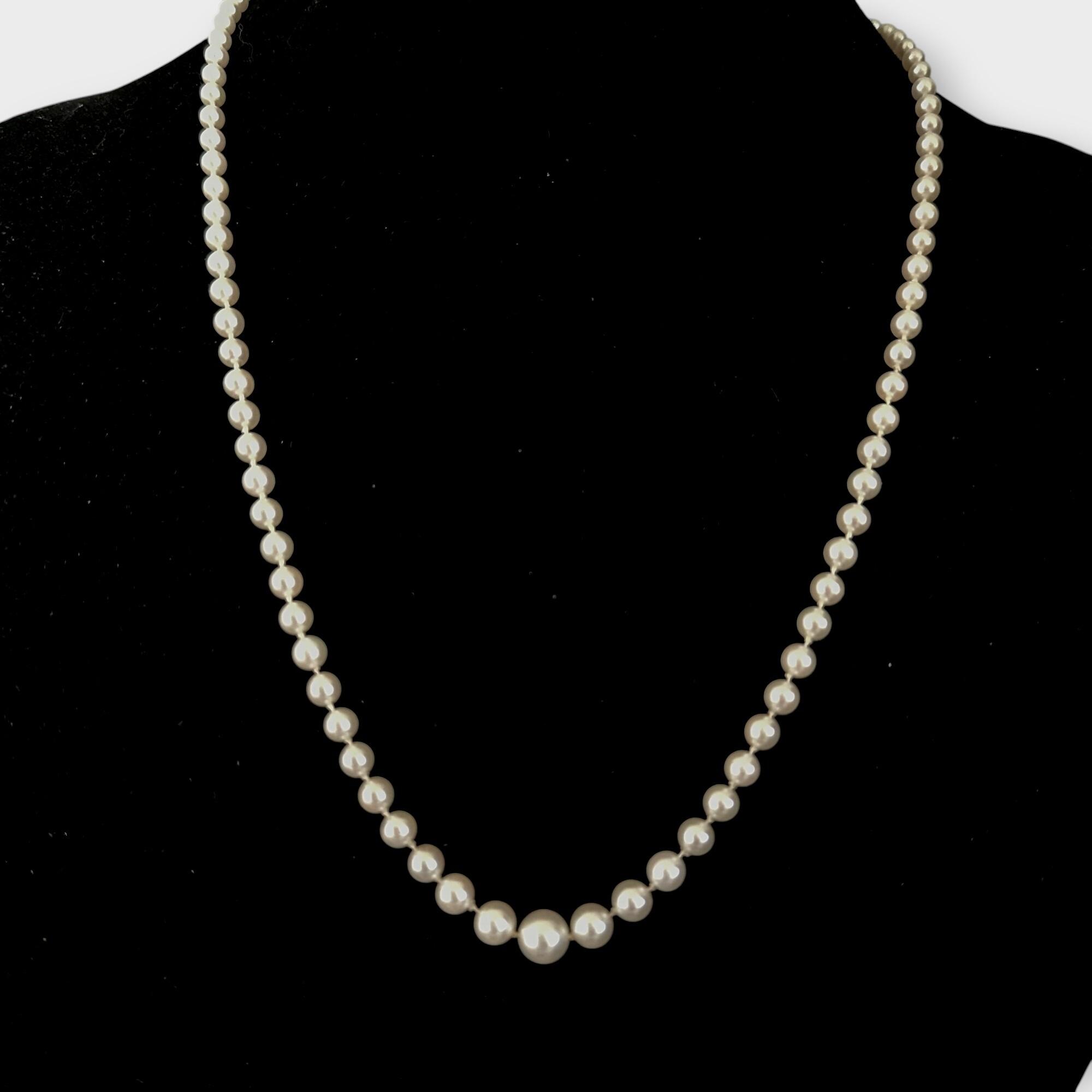 Mikimoto pearl necklace displayed on bust to show length and drape