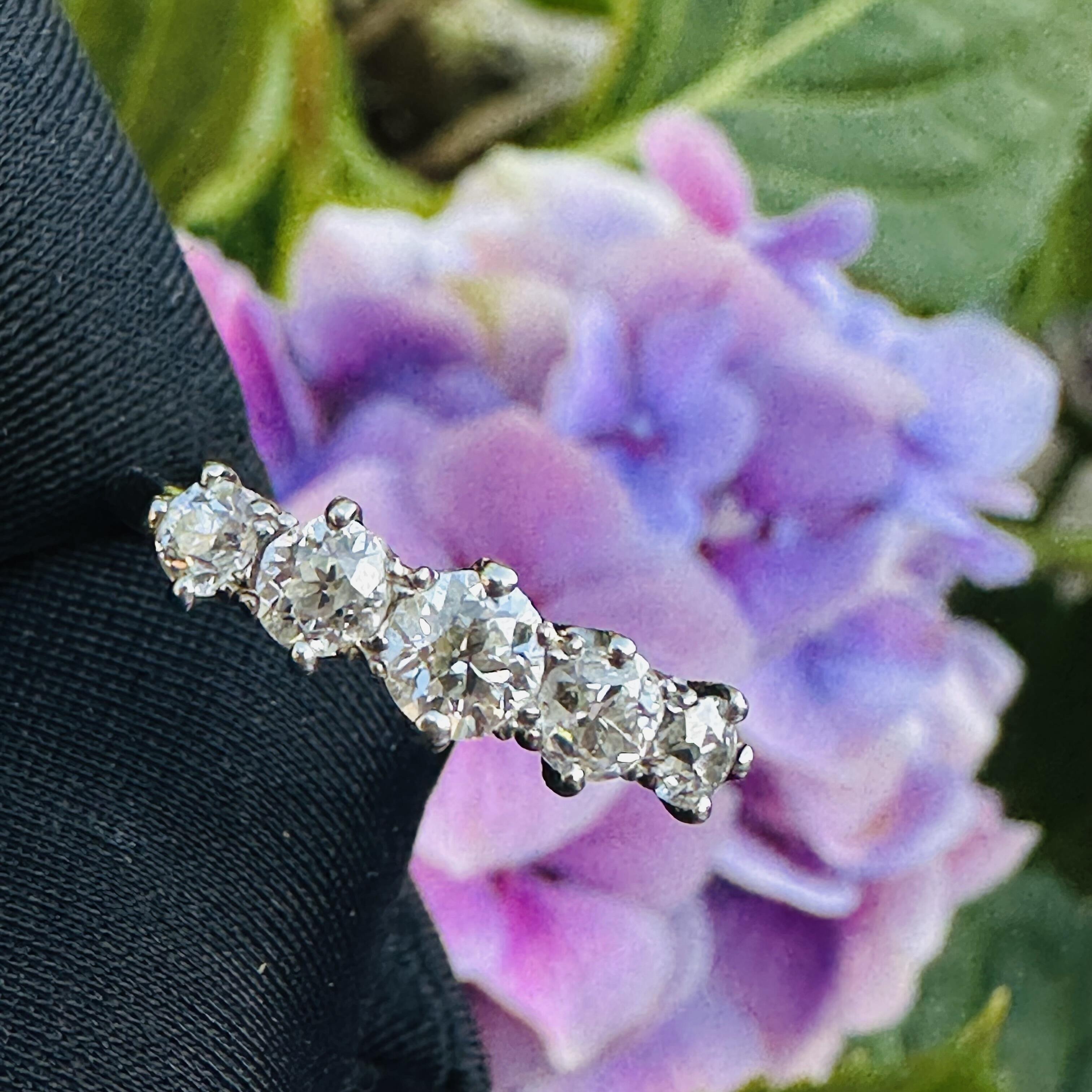 Antique Edwardian diamond ring in romantic vintage setting, featuring glowing old European cut diamonds in white gold