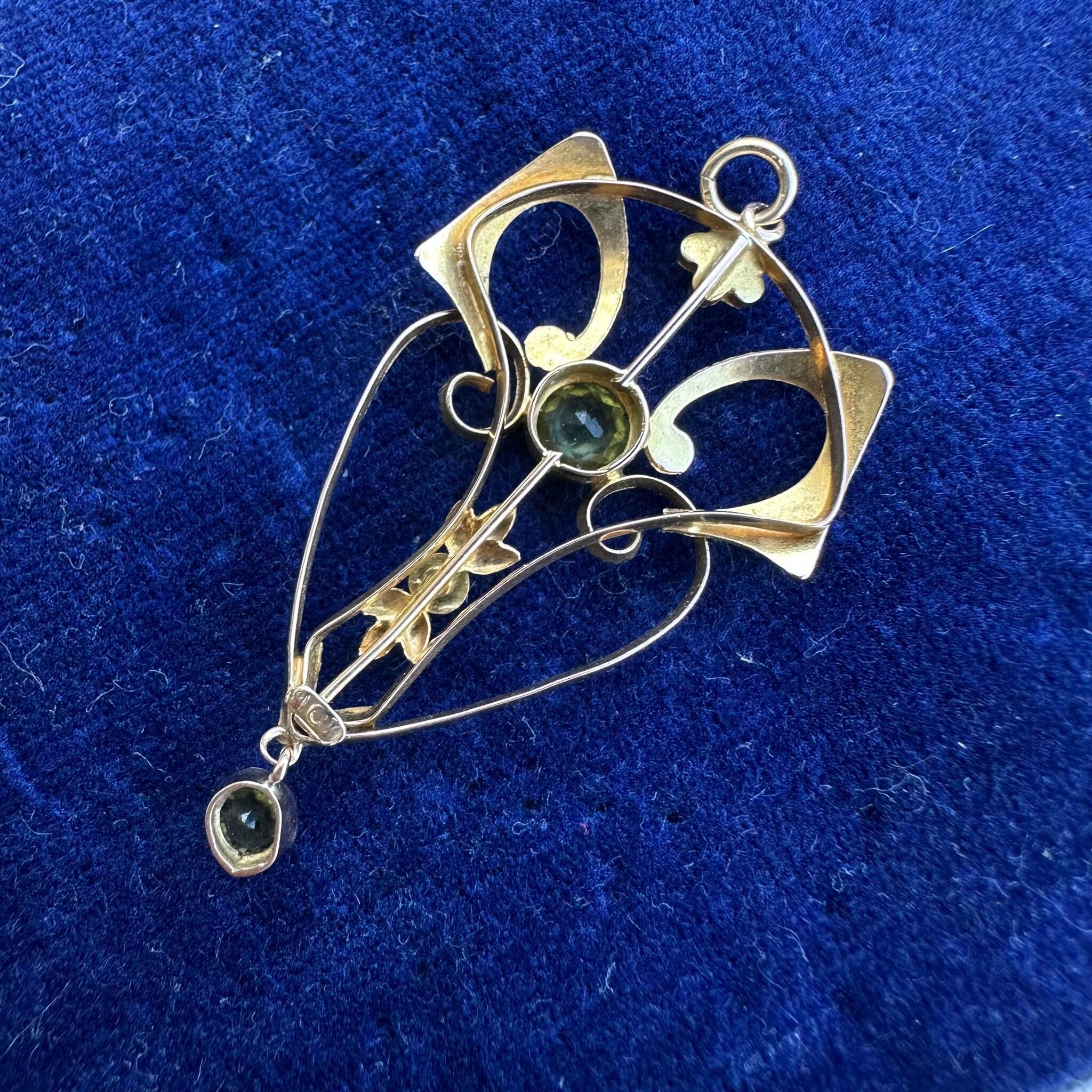 rear view of Rose Gold Peridot & Pearl Heart Pendant displayed on blue velvet antique box