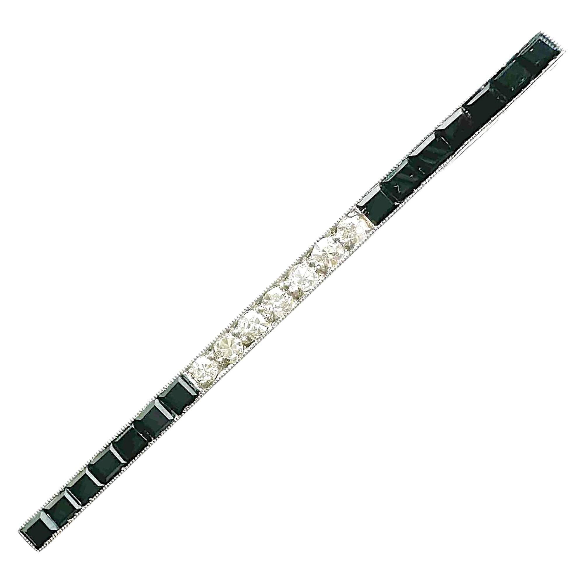 Art Deco line bar brooch with central diamond section flanked by sections of black onyx
