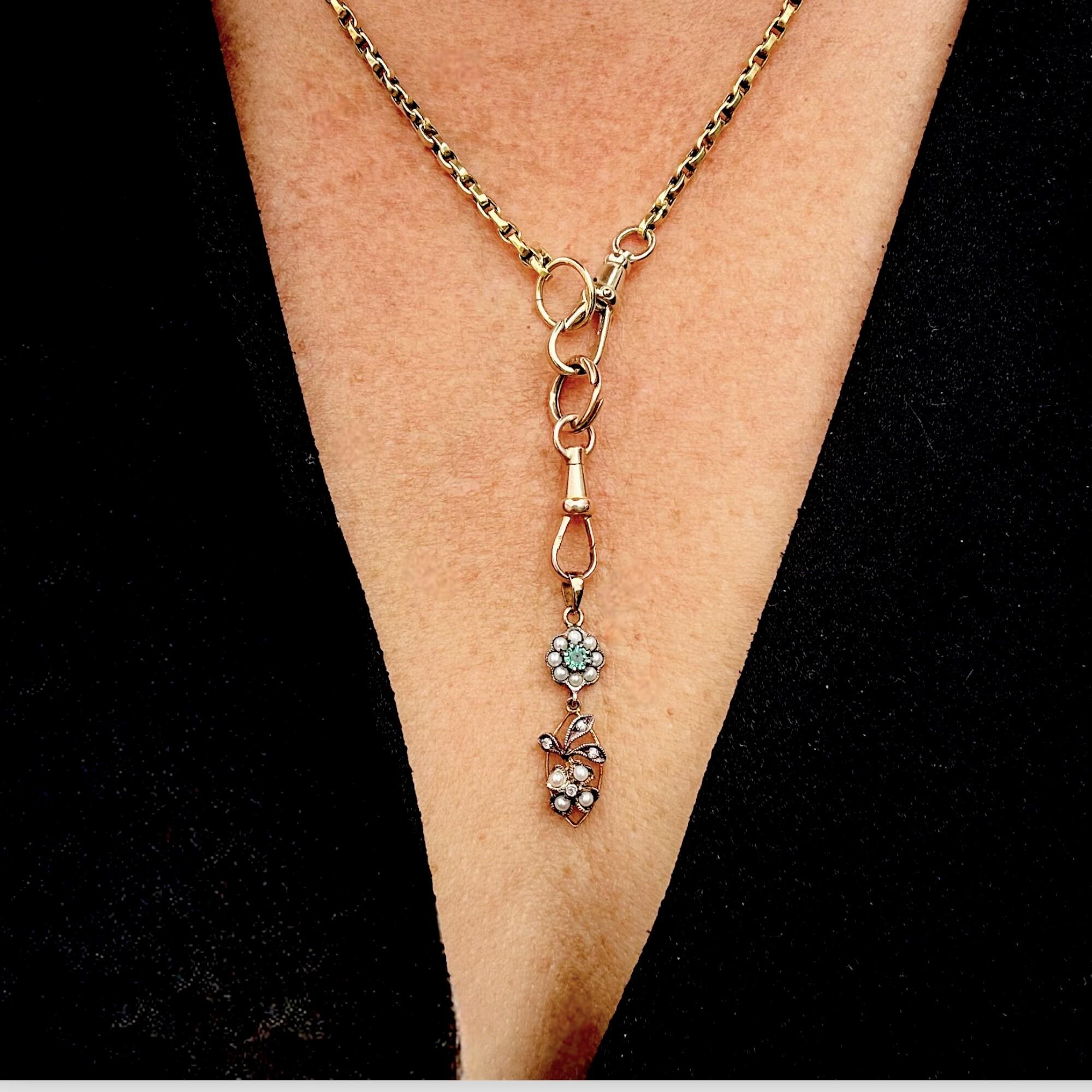 Edwardian Style Emerald, Pearl & Diamond Pendant in Silver & 9k Gold displayed on models neck.