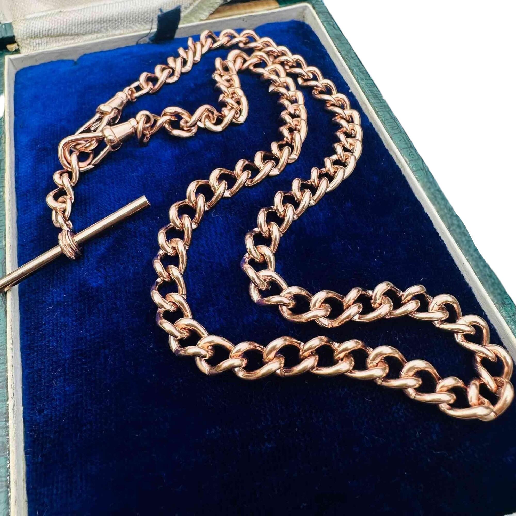 Close-up of Edwardian 9k rose gold chain with T-bar and dog clip fittings on white background