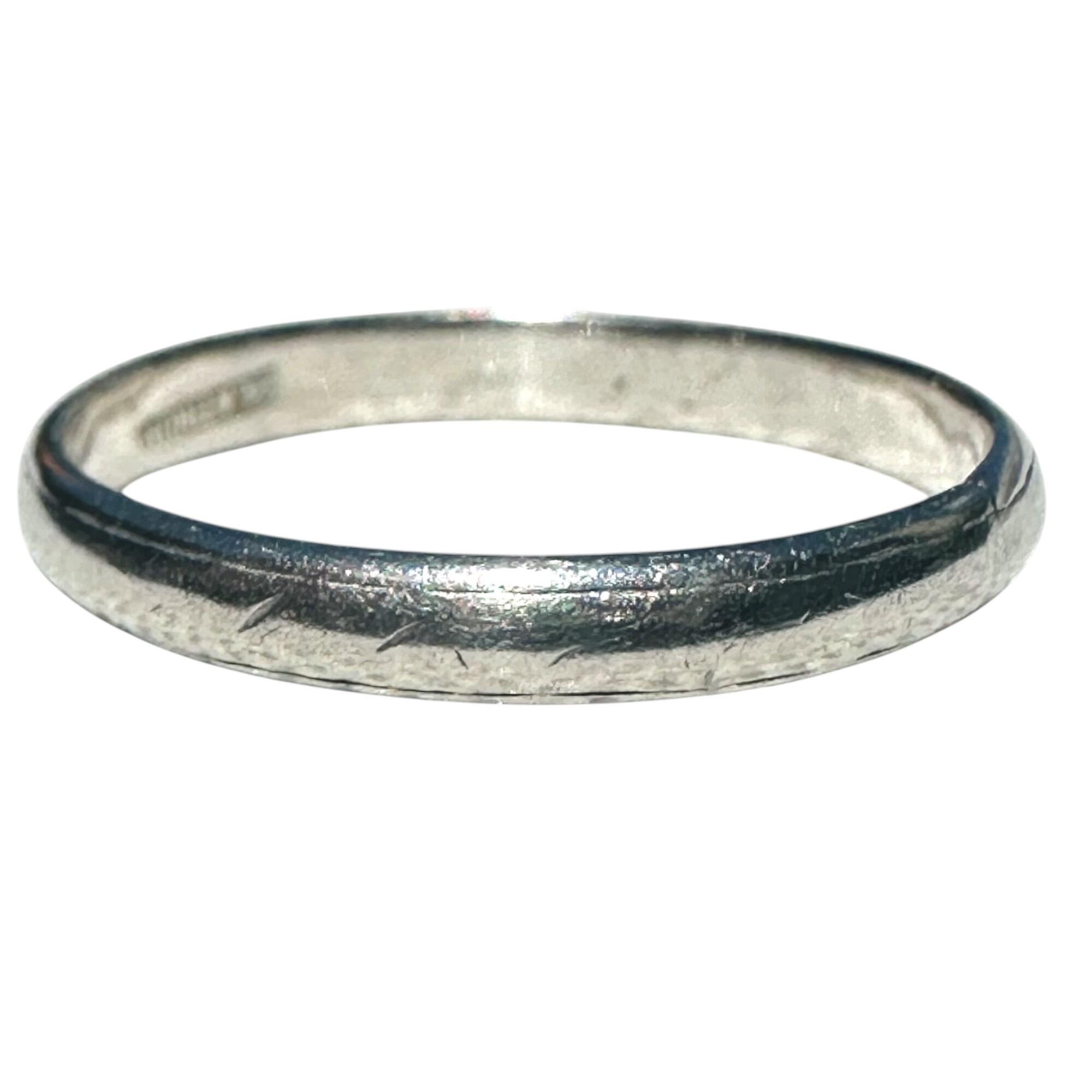 Antique platinum ring with bevelled edge and subtle dash pattern