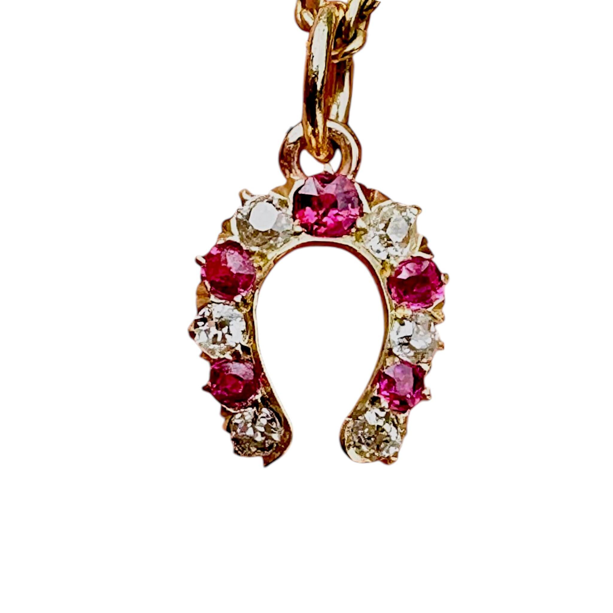 close up of Antique Victorian Ruby & Diamond Horseshoe Pendant with white background