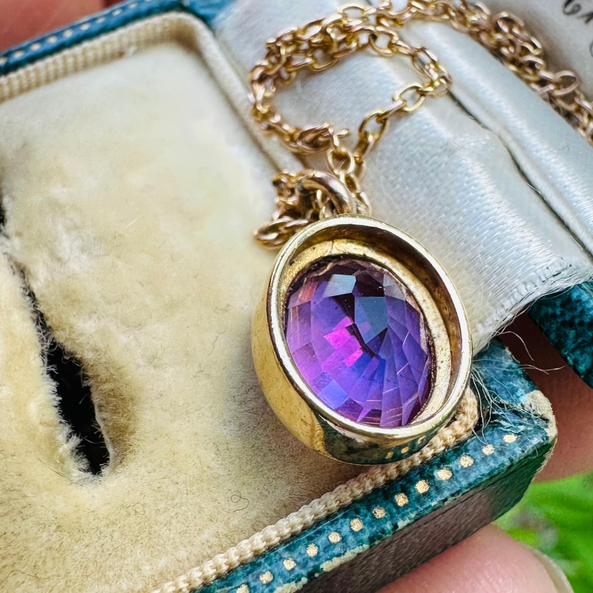 rear view of 14k Yellow Gold & Amethyst Pendant laying in antique box