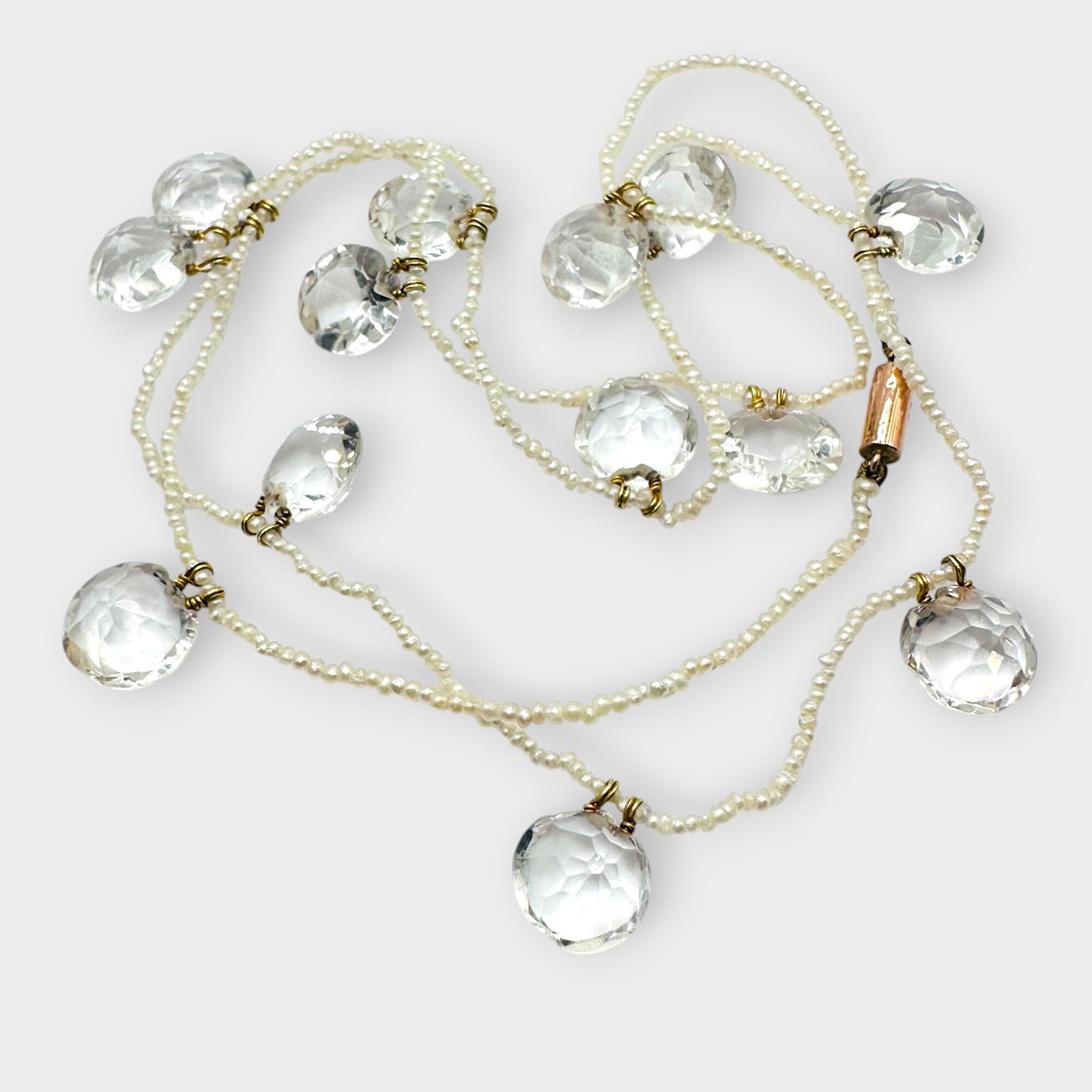 Edwardian rock crystal and natural seed pearl fringe necklace with 9k barrel clasp on grey background.