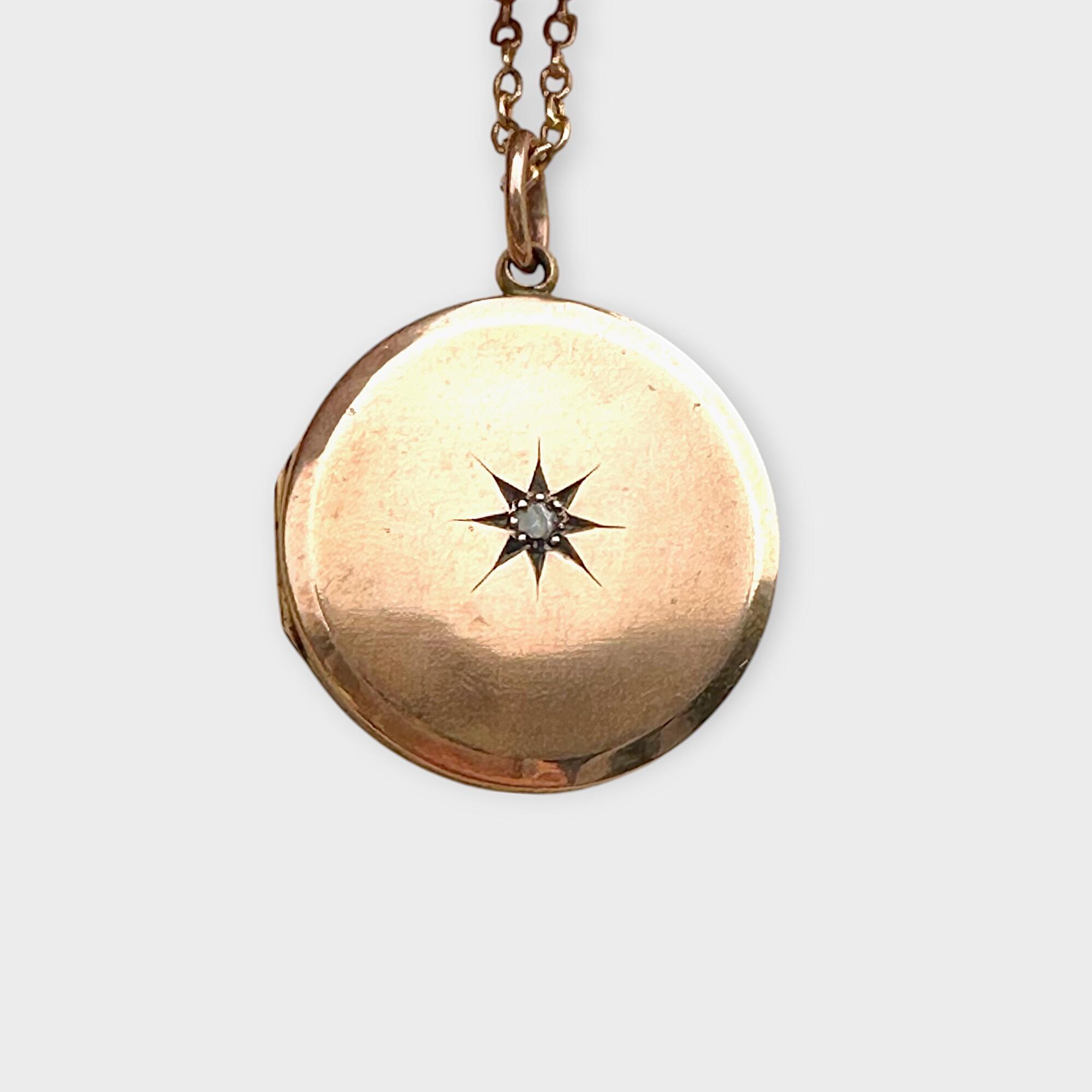 9k rose gold front and back circular locket with diamond centre in star setting on grey background