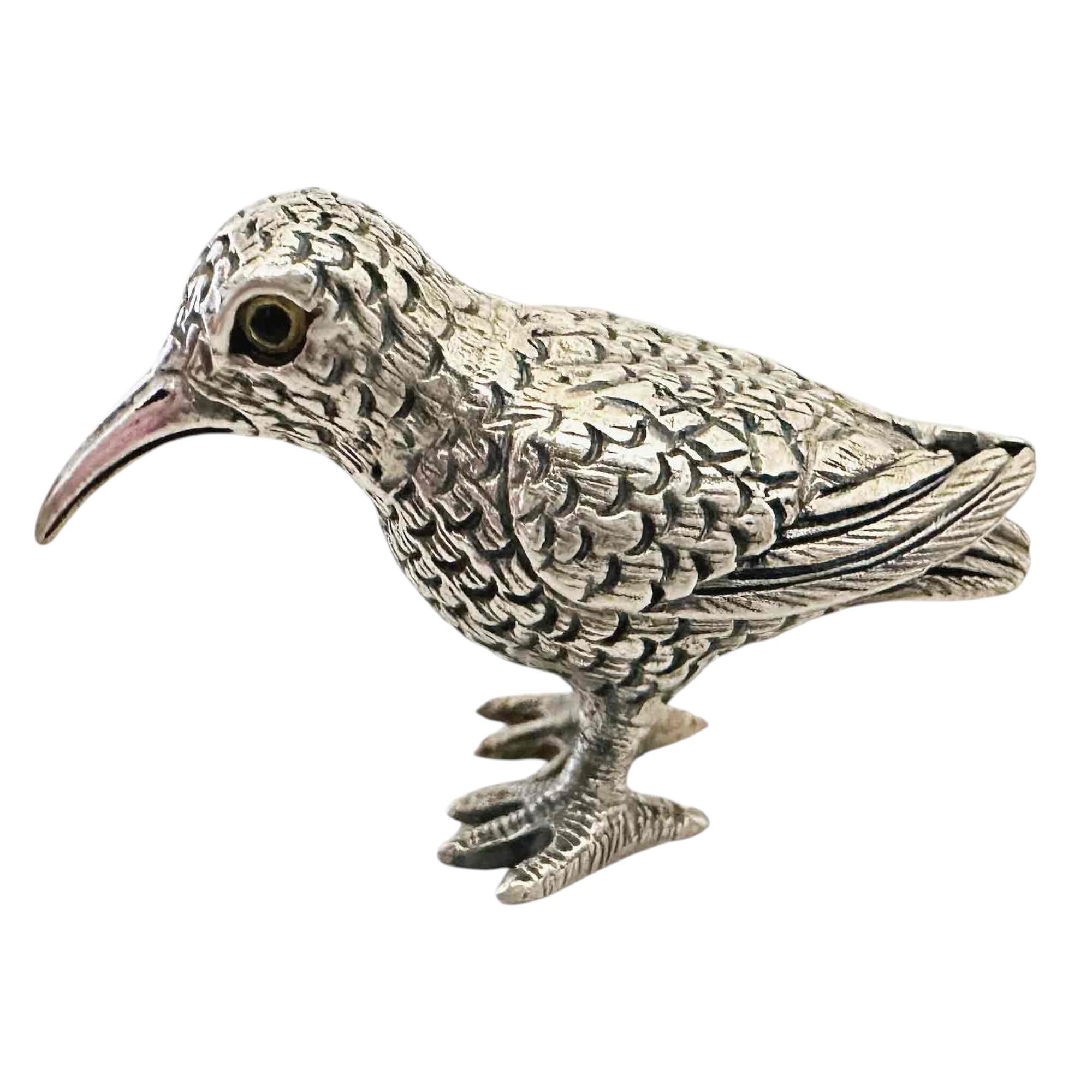 solid sterling silver bird figurine with yellow enamel eyes