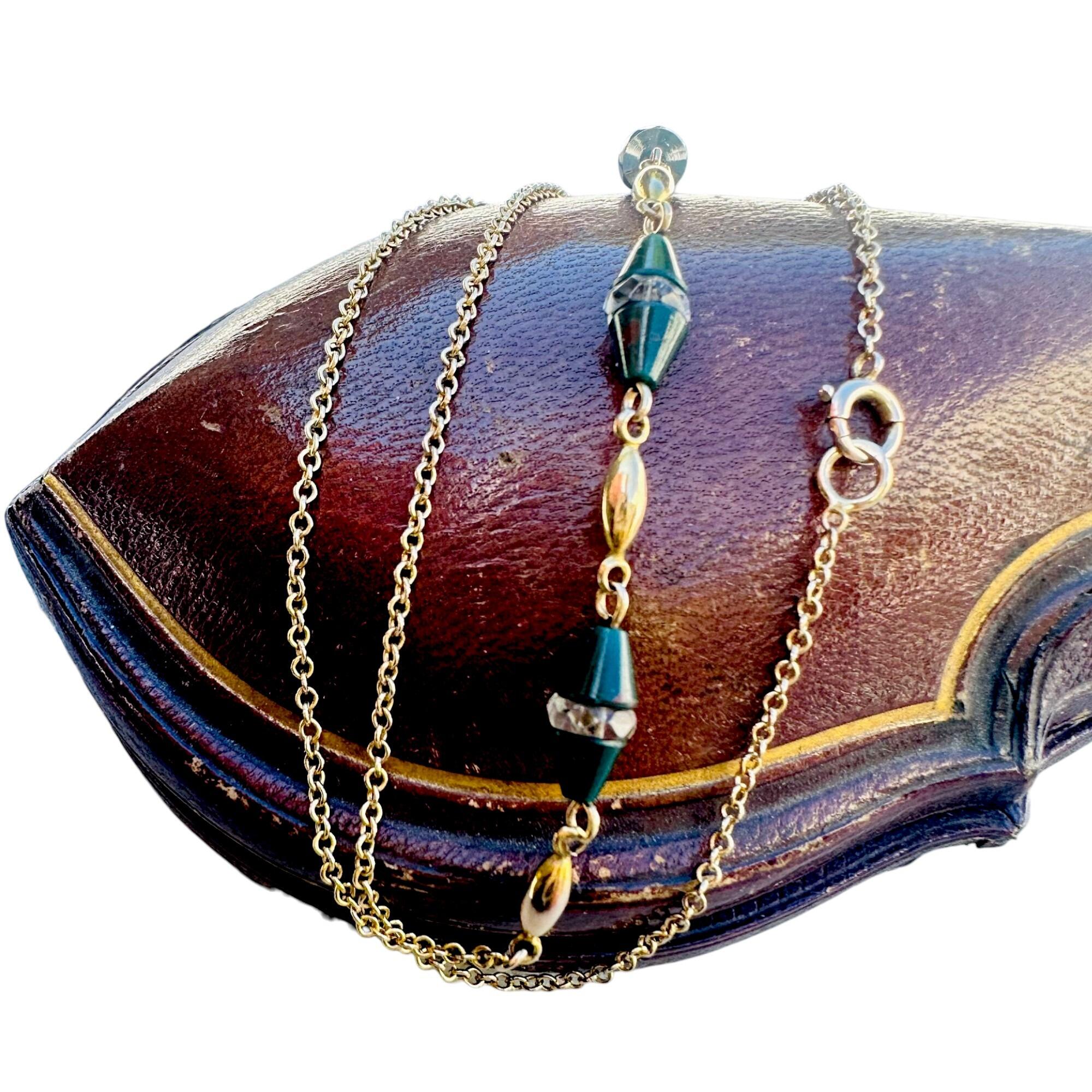 Antique Art Deco 9k Gold Bloodstone & Rock Crystal Bead Chain displayed on red leather box with white background