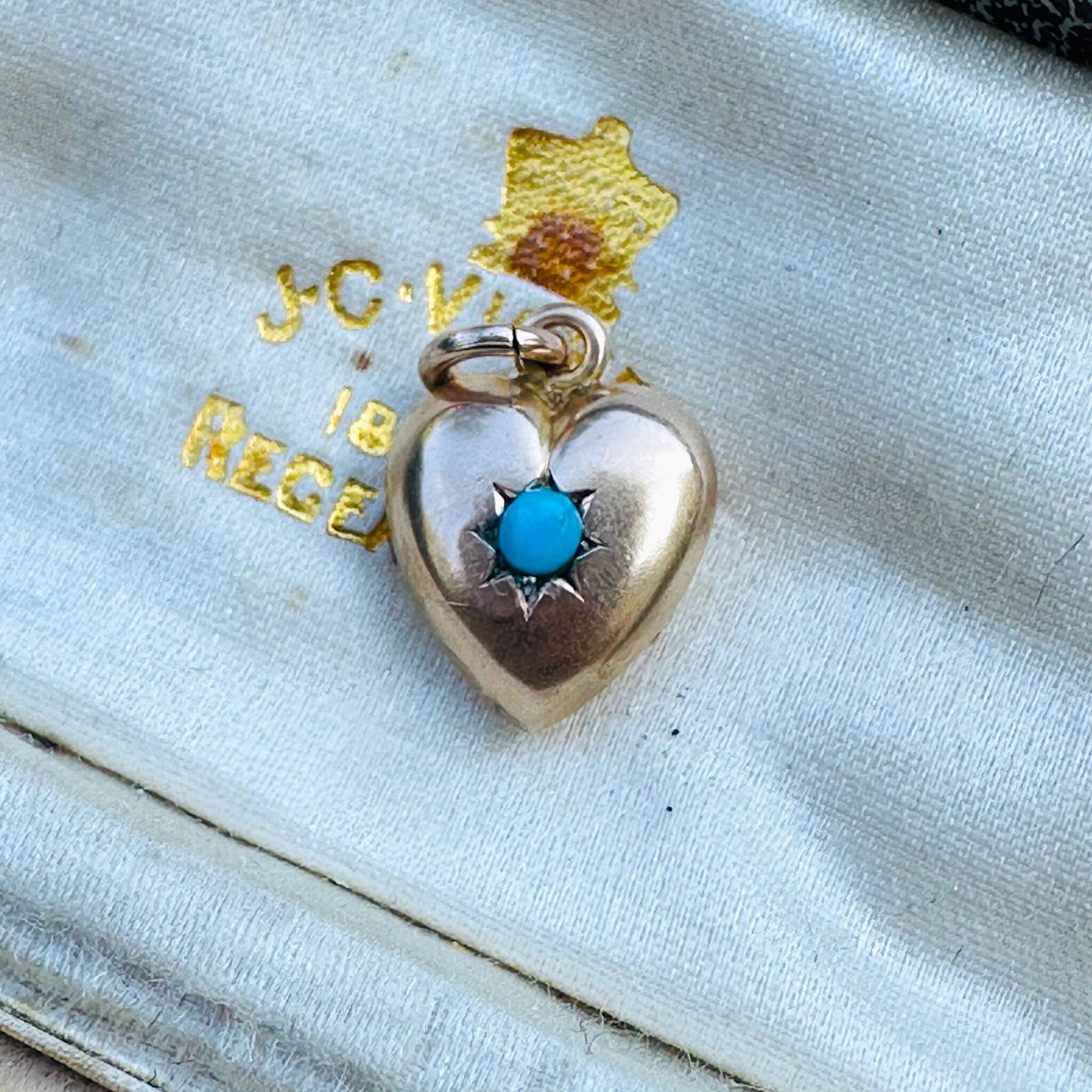 Antique Art Deco, Gold & Turquoise Puffy Heart Pendant  laying on a antique box