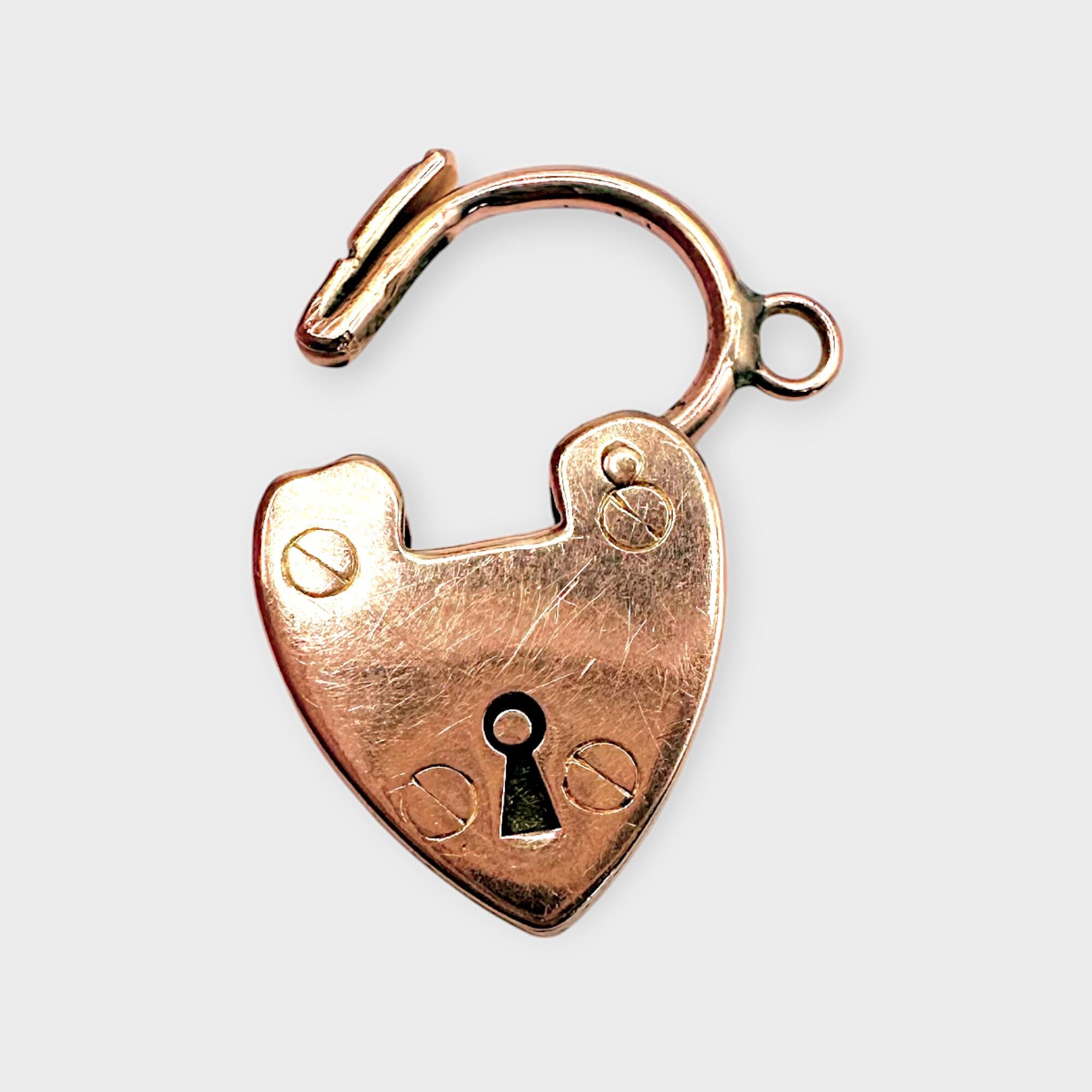 antique 9ct rose gold heart padlock on a grey background