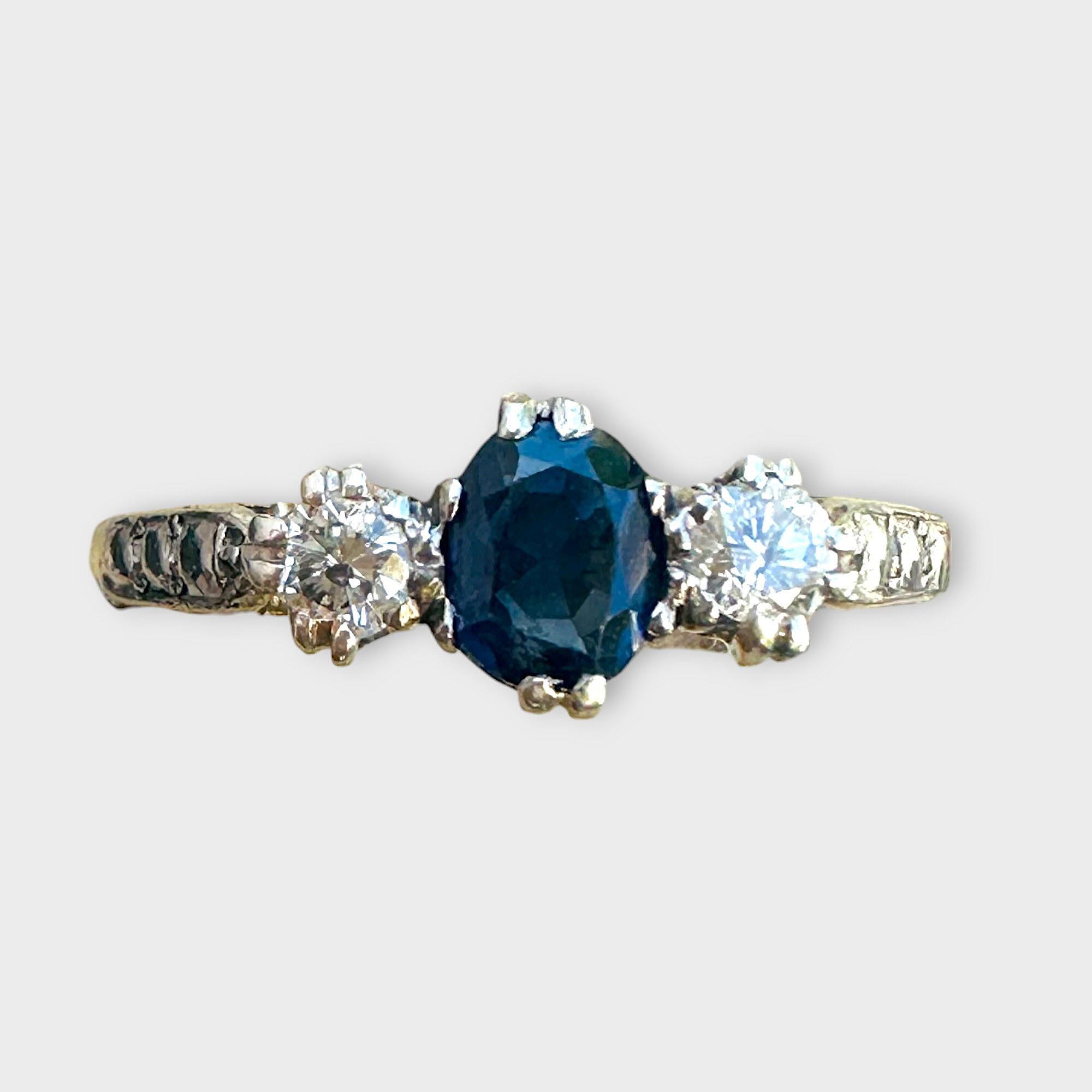 Stunning sapphire and diamond ring set in 18ct yellow gold with platinum shoulders with grey background.