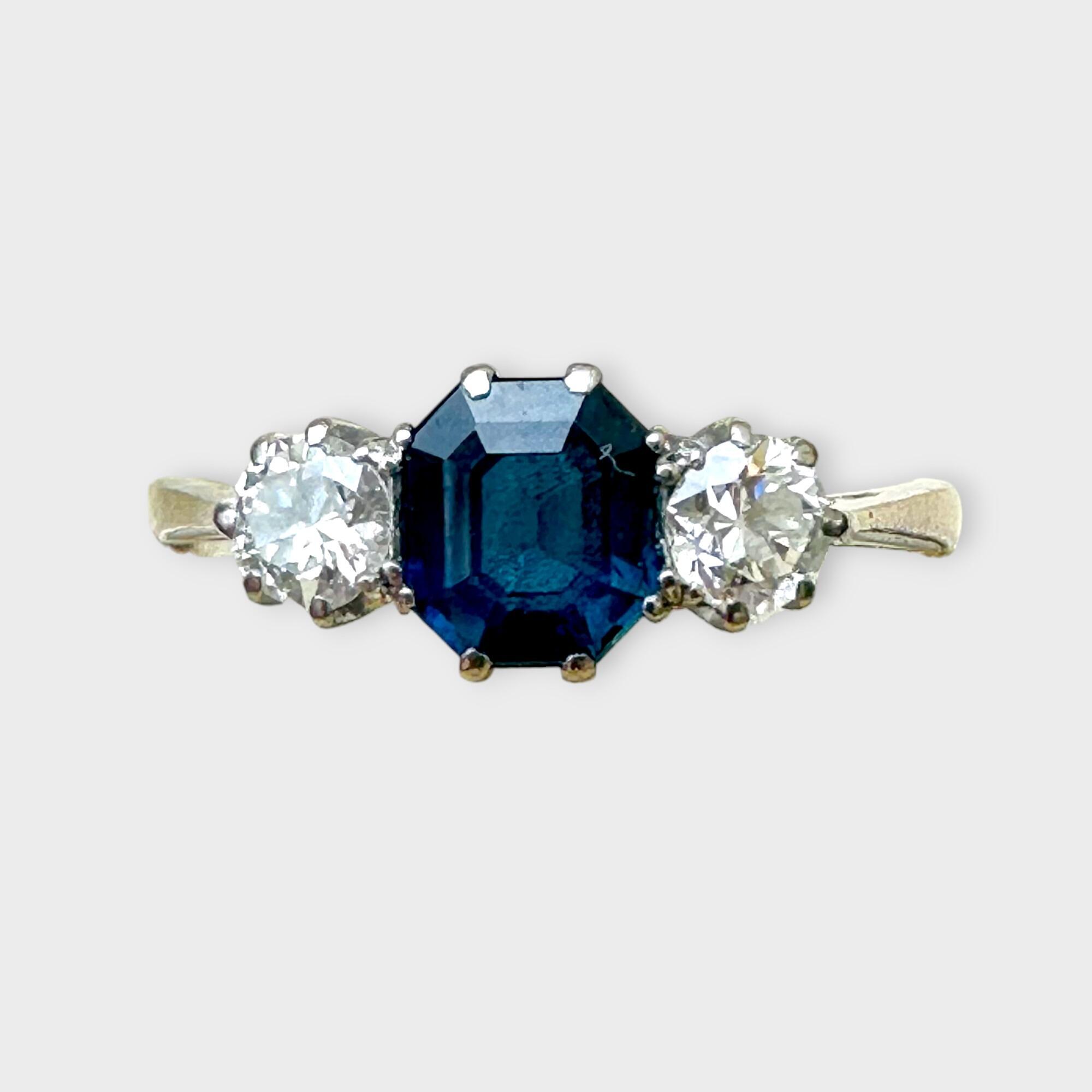 Vintage three-stone sapphire and diamond ring in platinum, 1950s design.