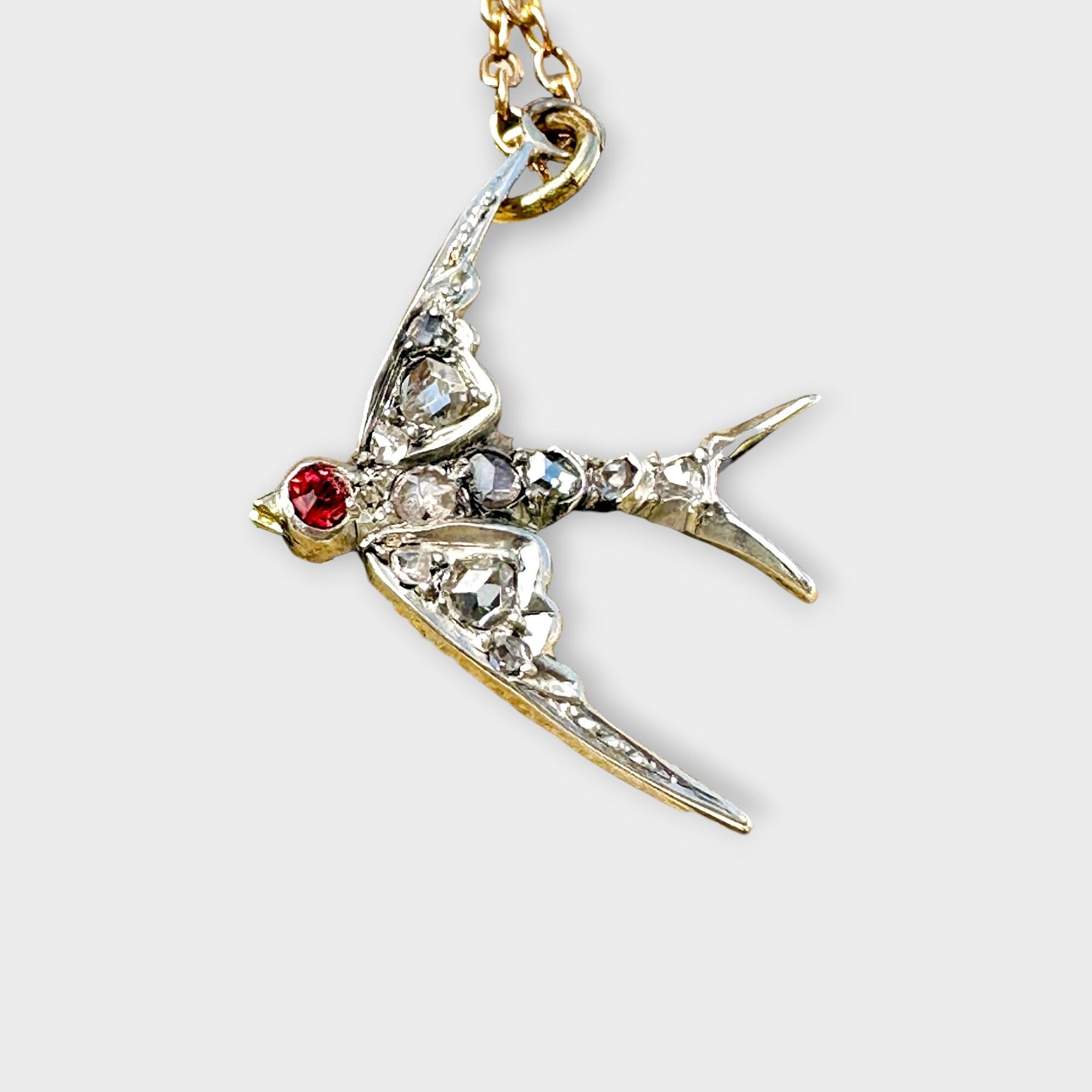 Vintage bird charm featuring diamond-studded body and ruby head