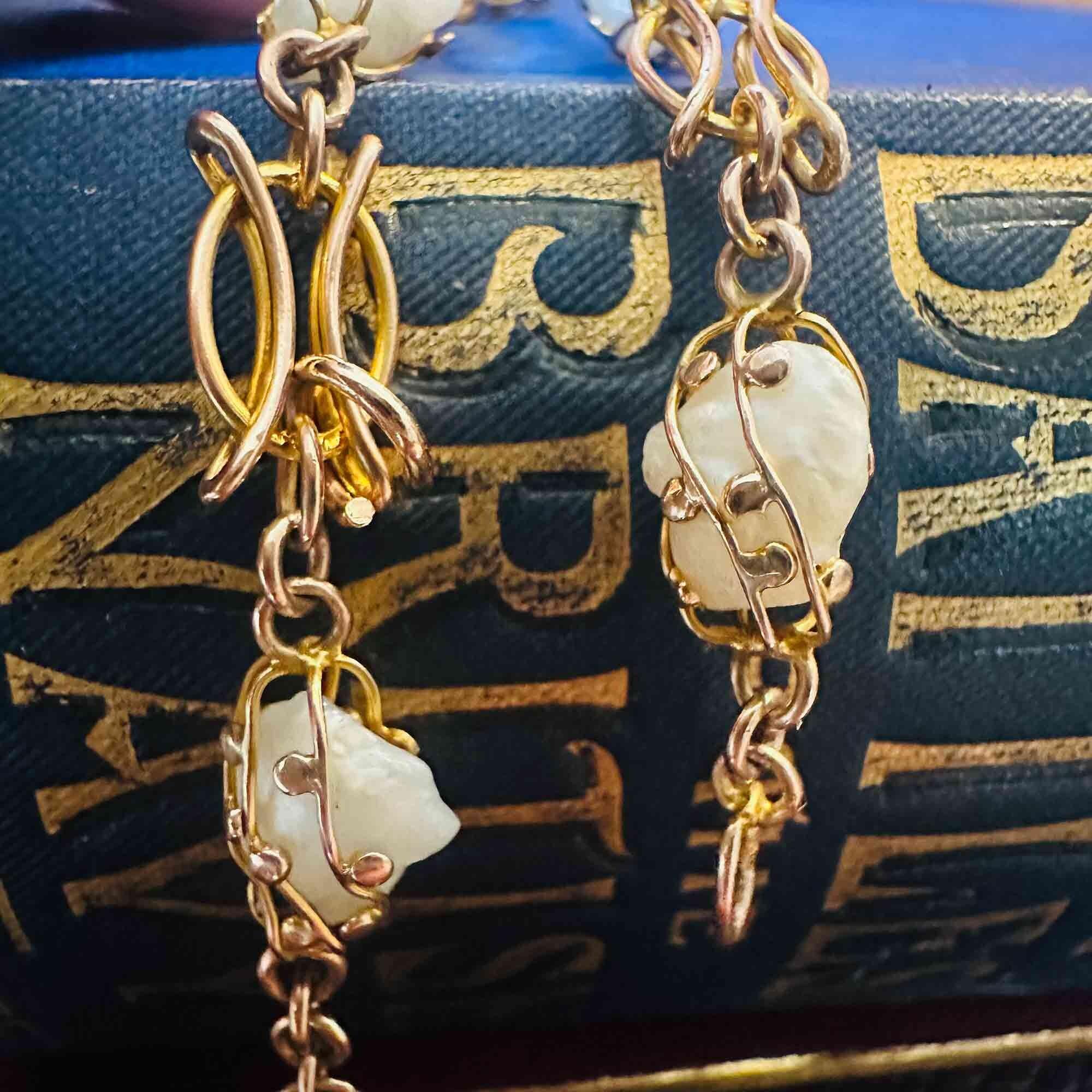 Art nouveau 9ct rose gold cage pearl bracelet on antique books