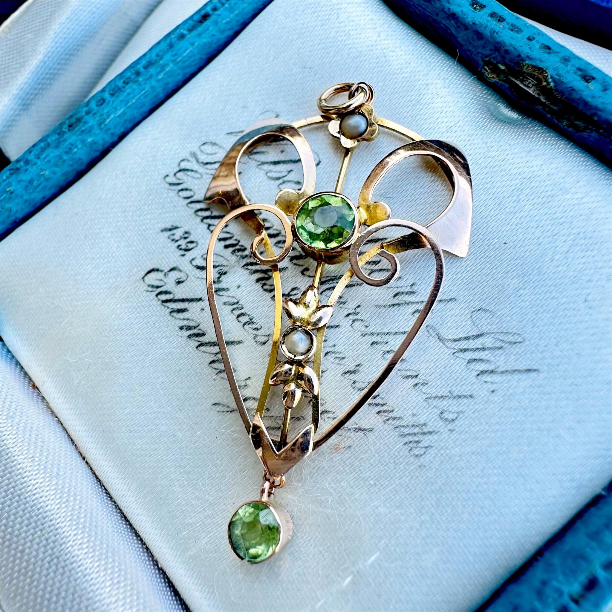 Rose Gold Peridot & Pearl Heart Pendant displayed on antique box