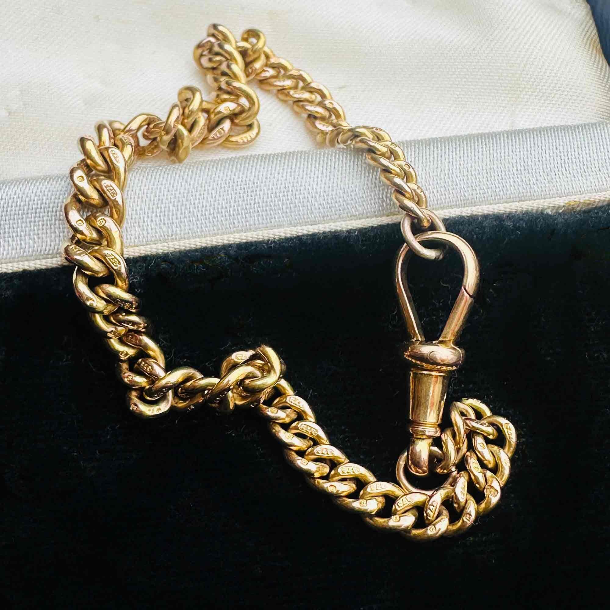 Gold Albert Curb Link  Bracelet & Dog Clip Clasp displayed laying on antique box