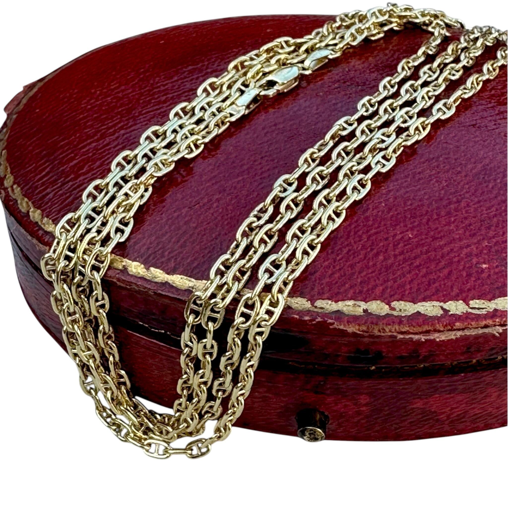 9ct Gold Mariner Anchor Link Chain Necklace laying on red antique box