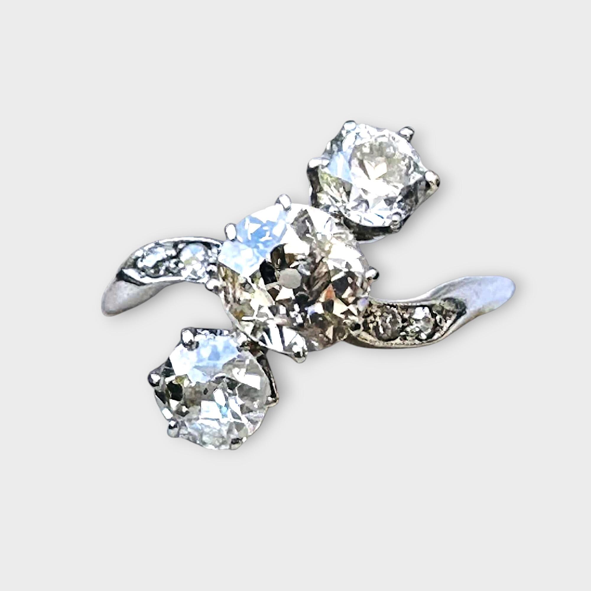 Art Deco diagonally set three stone old cut diamond engagement ring in platinum