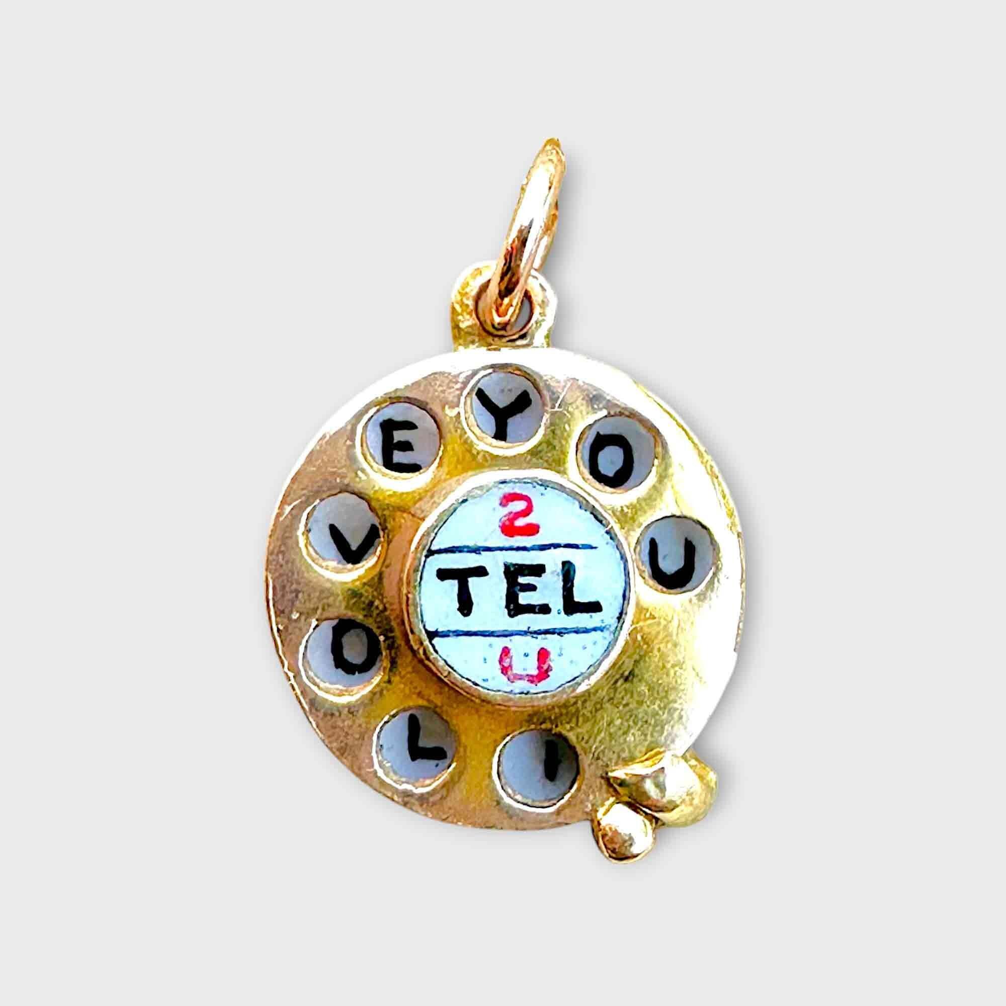 Vintage 9ct gold I love you telephone charm. grey background