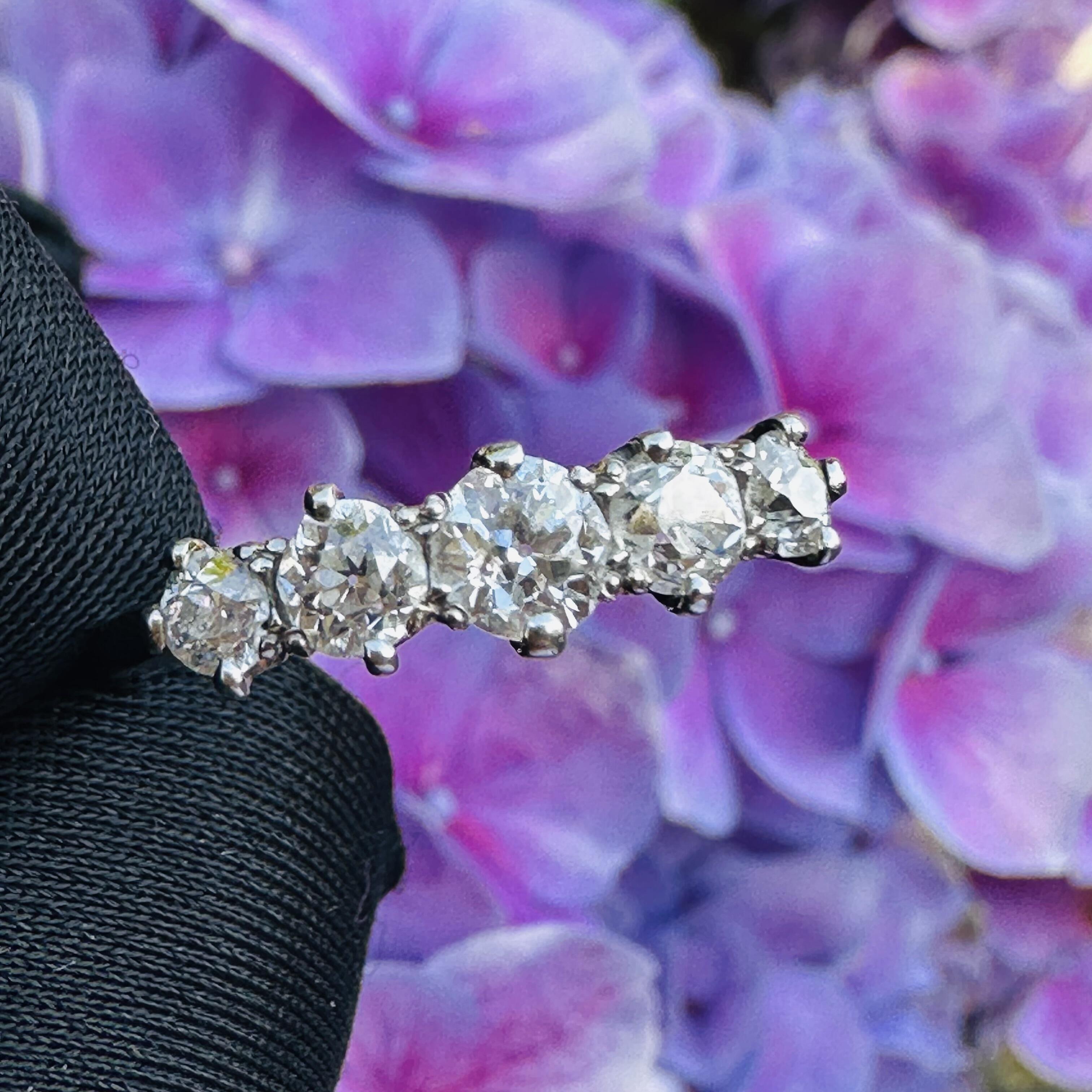 Antique Edwardian diamond ring in romantic vintage setting, featuring glowing old European cut diamonds in white gold