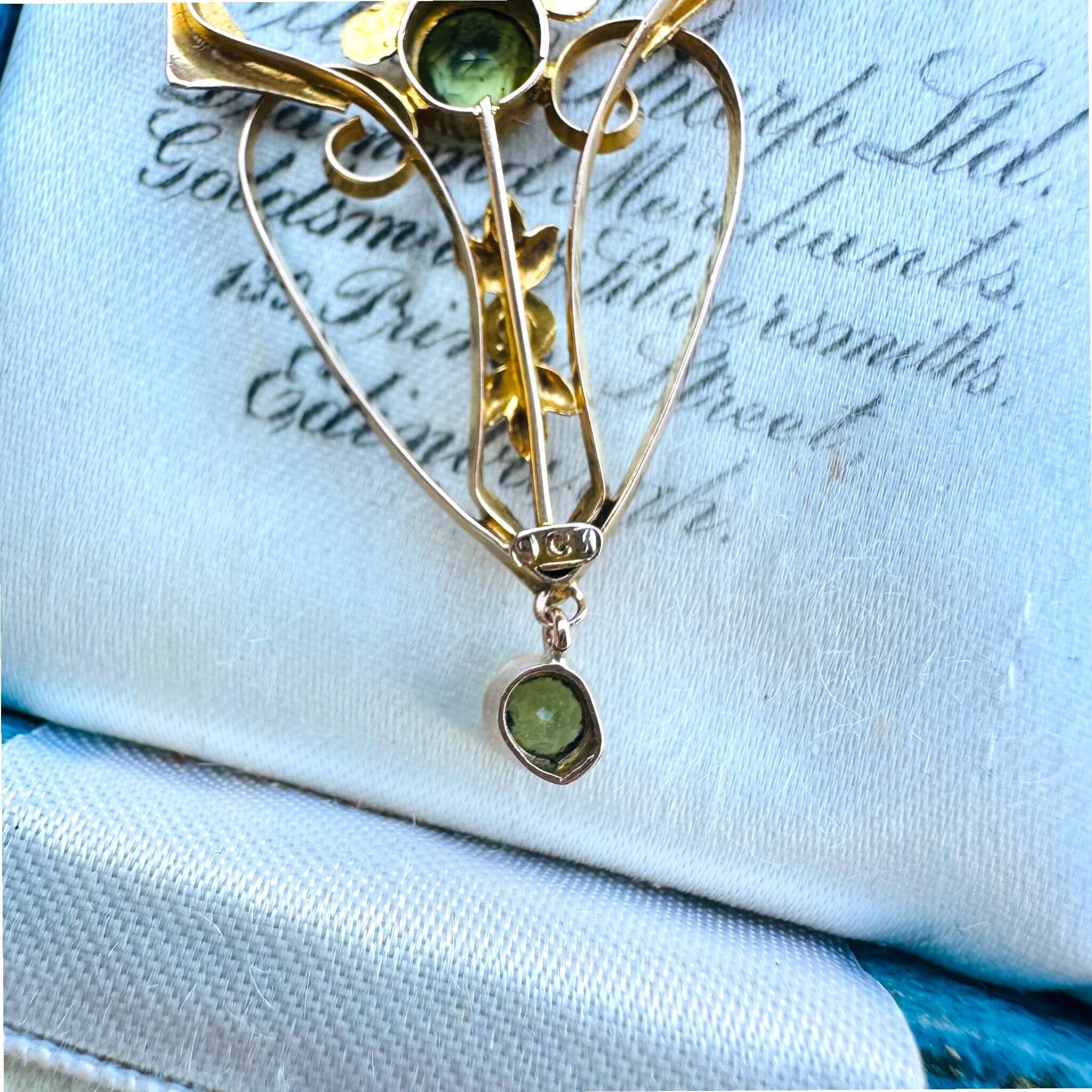 Rose Gold Peridot & Pearl Heart Pendant displayed on antique box