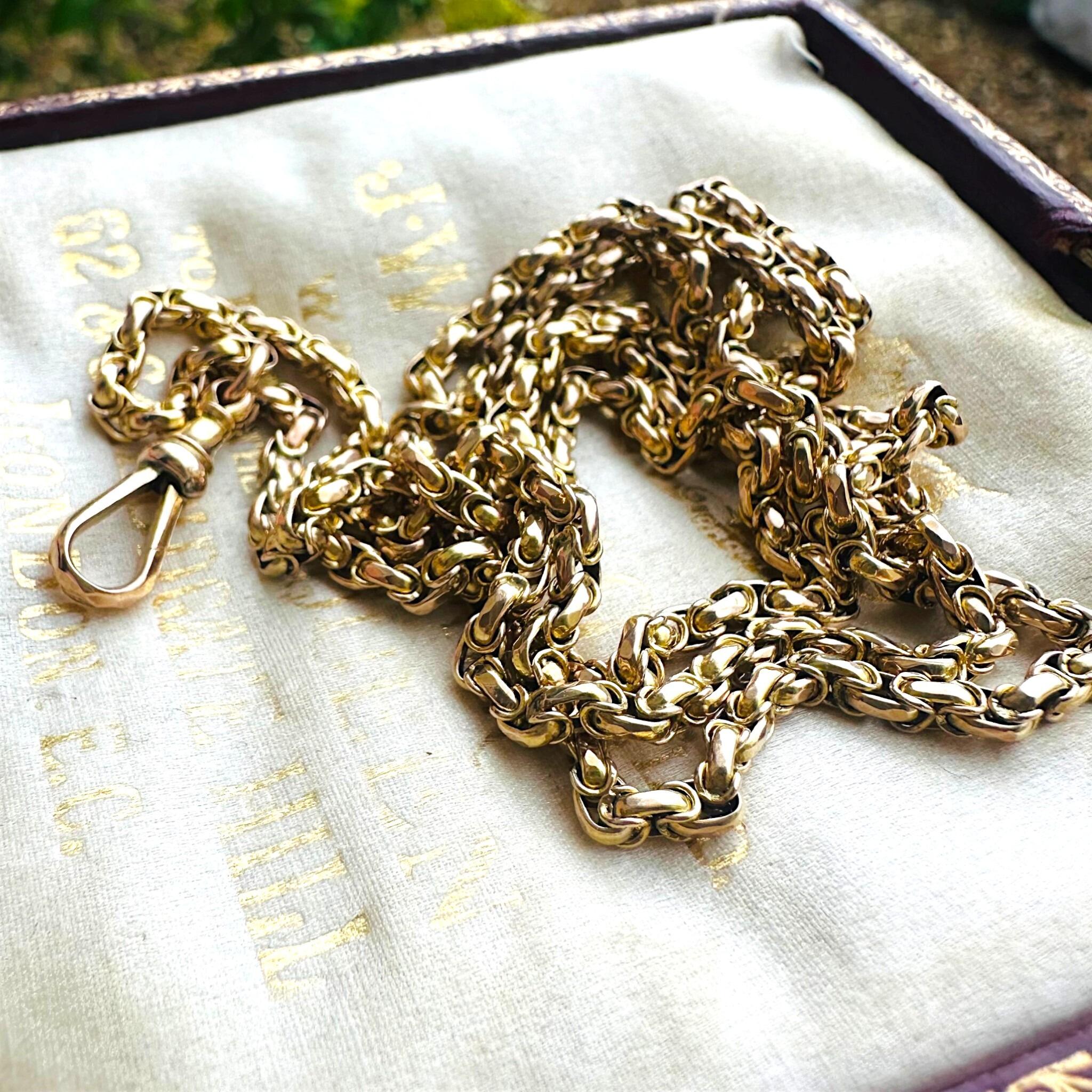 Victorian Gold Fancy Link Long Chain Necklace & Dog Clip  laying on antique box