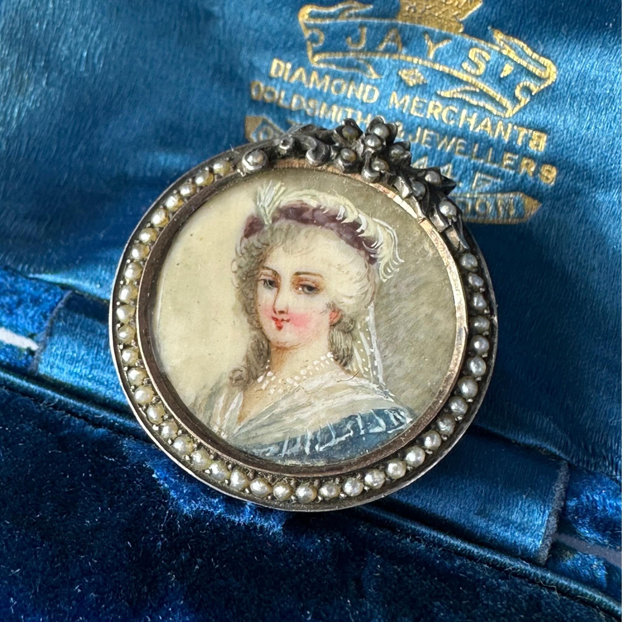 Georgian Marie Antoinette & Silver Seed Pearl Portrait Brooch displayed on blue antique box