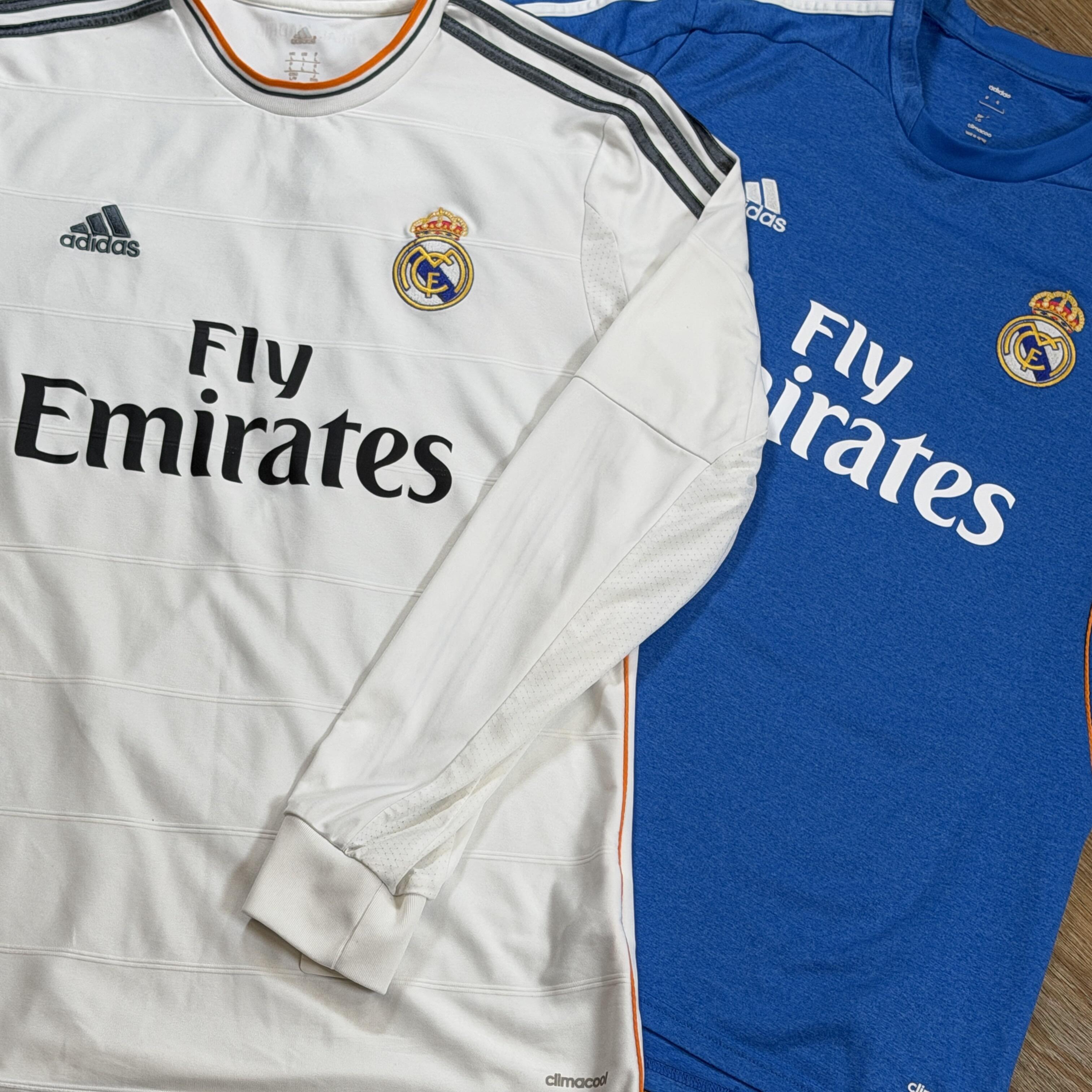 Two Cristiano Ronaldo Real Madrid shirts: 2013/14 home long-sleeve shirt on the left and 2013/14 away shirt on the right, both Ronaldo #7