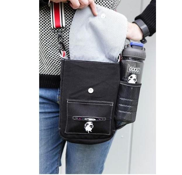 DOOG Walkie Shoulder Bag in Black opened with DOOG water bottle